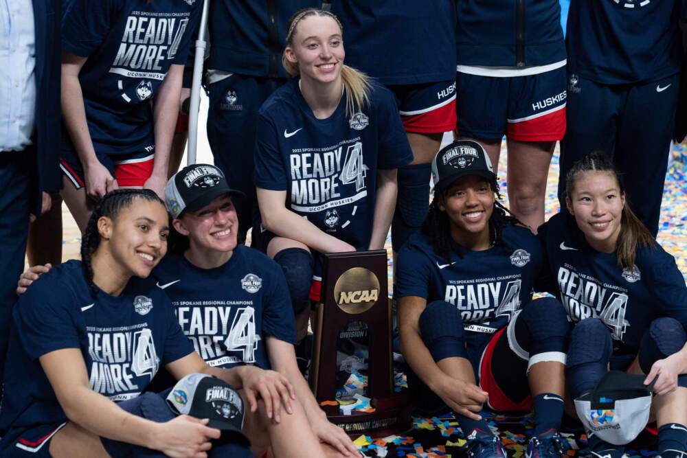 UConn players from left, Azzi Fudd, Ashlynn Shade, Paige Bueckers, KK Arnold and Kaitlyn Chen pose with a trophy after a win over Southern California in the Elite Eight. (Jenny Kane/AP)