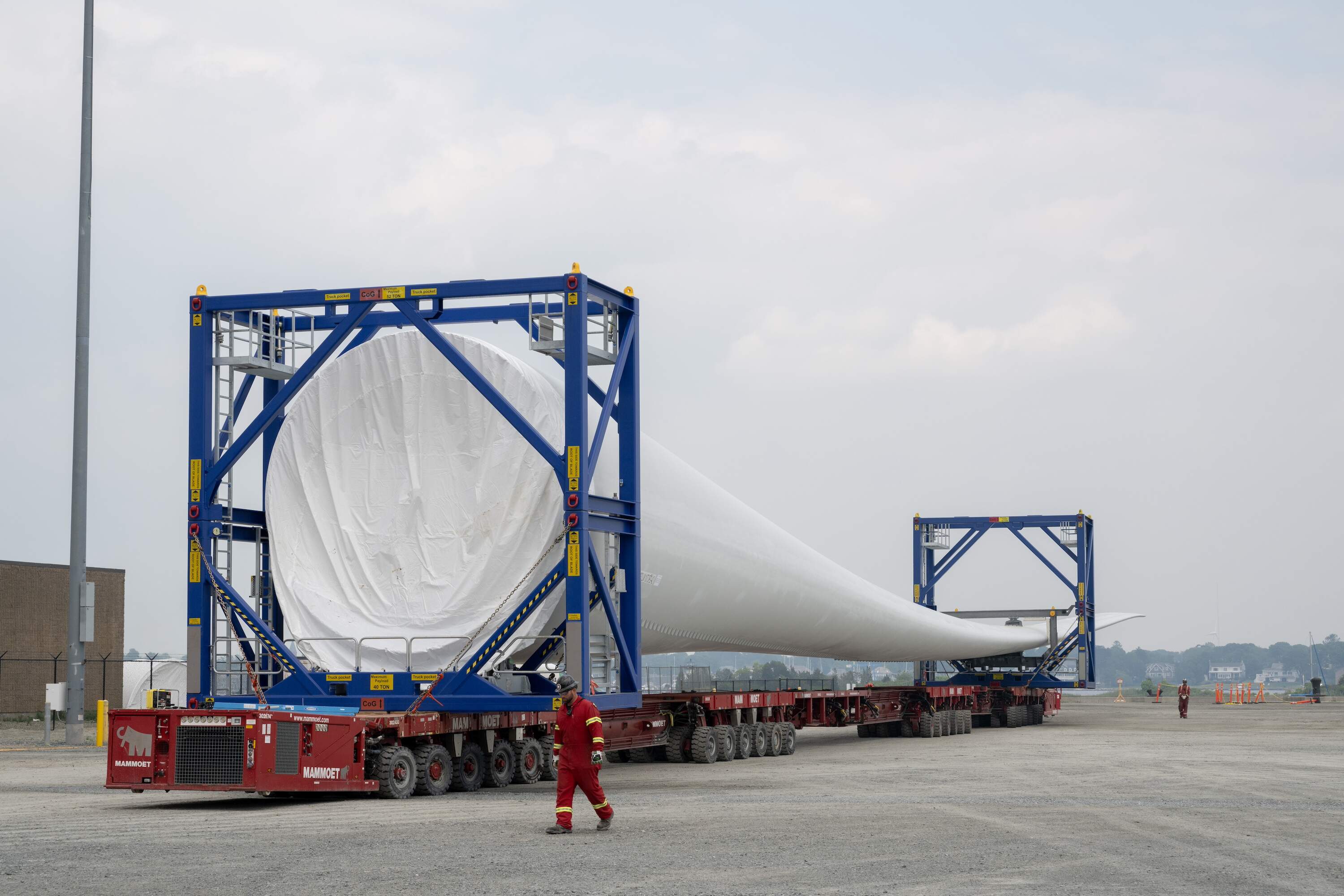 Workers transport an offshore wind turbine blade for Vineyard Wind on Thursday, June 8, 2023, in New Bedford, Mass (Raquel C. Zaldívar/New England News Collaborative)