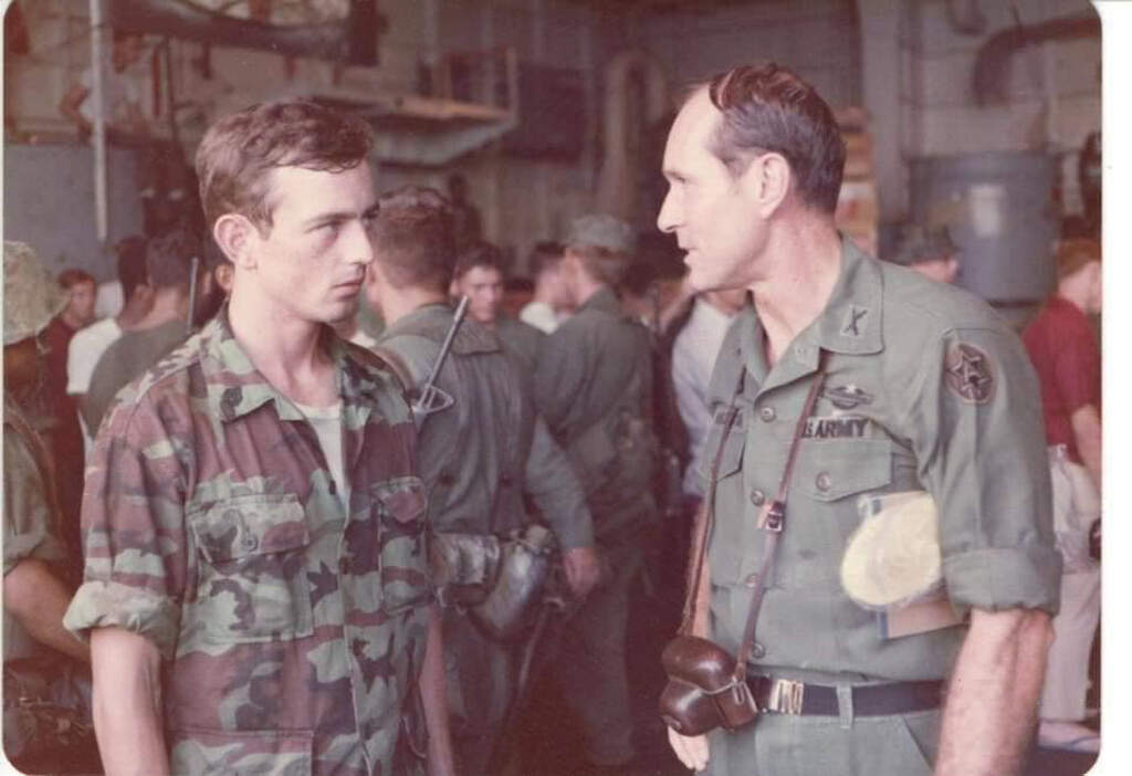 Sgt. Kevin Maloney, left, with Col. John Madison, aboard the U.S.S. Okinawa following the April 30 evacuation of Saigon. South China Sea, May 1, 1975. (Courtesy Kevin Maloney; Photo by Stuart Herrington)