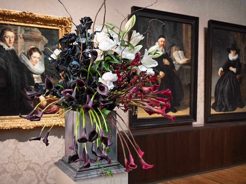 Floral arrangement by the Scituate Garden Club. Left to right: Jacob Jordaens, Portrait of a Young Married Couple (detail), about 1621–22. Oil on panel. Robert Dawson Evans Collection; Rembrandt Harmensz. van Rijn, Reverend Johannes Elison, 1634. Oil on canvas. William K. Richardson Fund; Rembrandt Harmensz. van Rijn, Maria Bockenolle (Wife of Johannes Elison) (detail), 1634. Oil on canvas. William K. Richardson Fund.