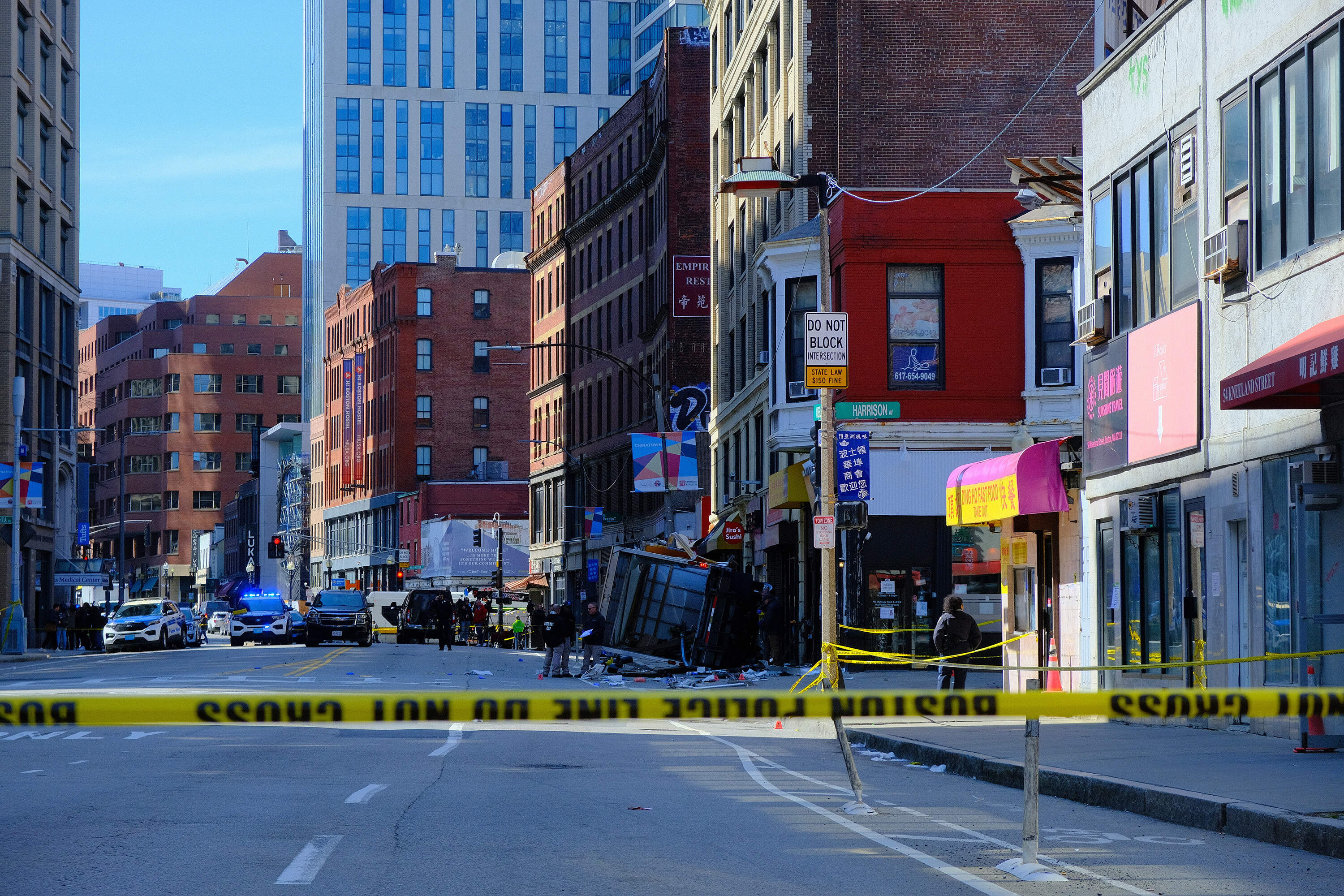 Police tape block off the area where a boxtruck crashed in Boston's Chinatown. (Patrick Madden/WBUR)