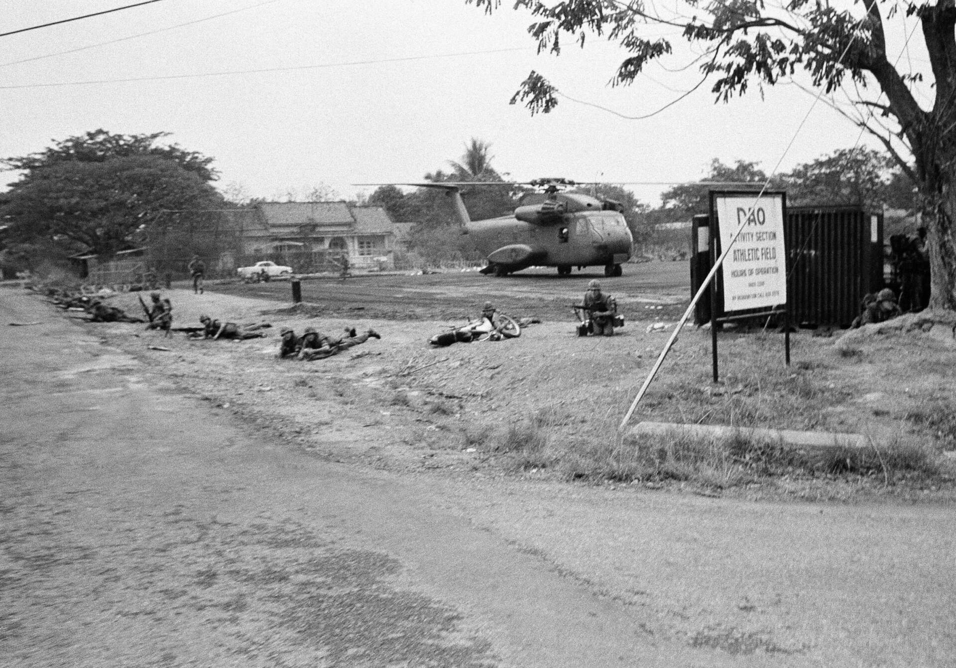 U.S. Marines drop to prone firing position to guard helicopter at landing zone at former U.S. military headquarters at Tan Son Nhut airport during the evacuation from Saigon on April 29, 1975. (AP file photo)