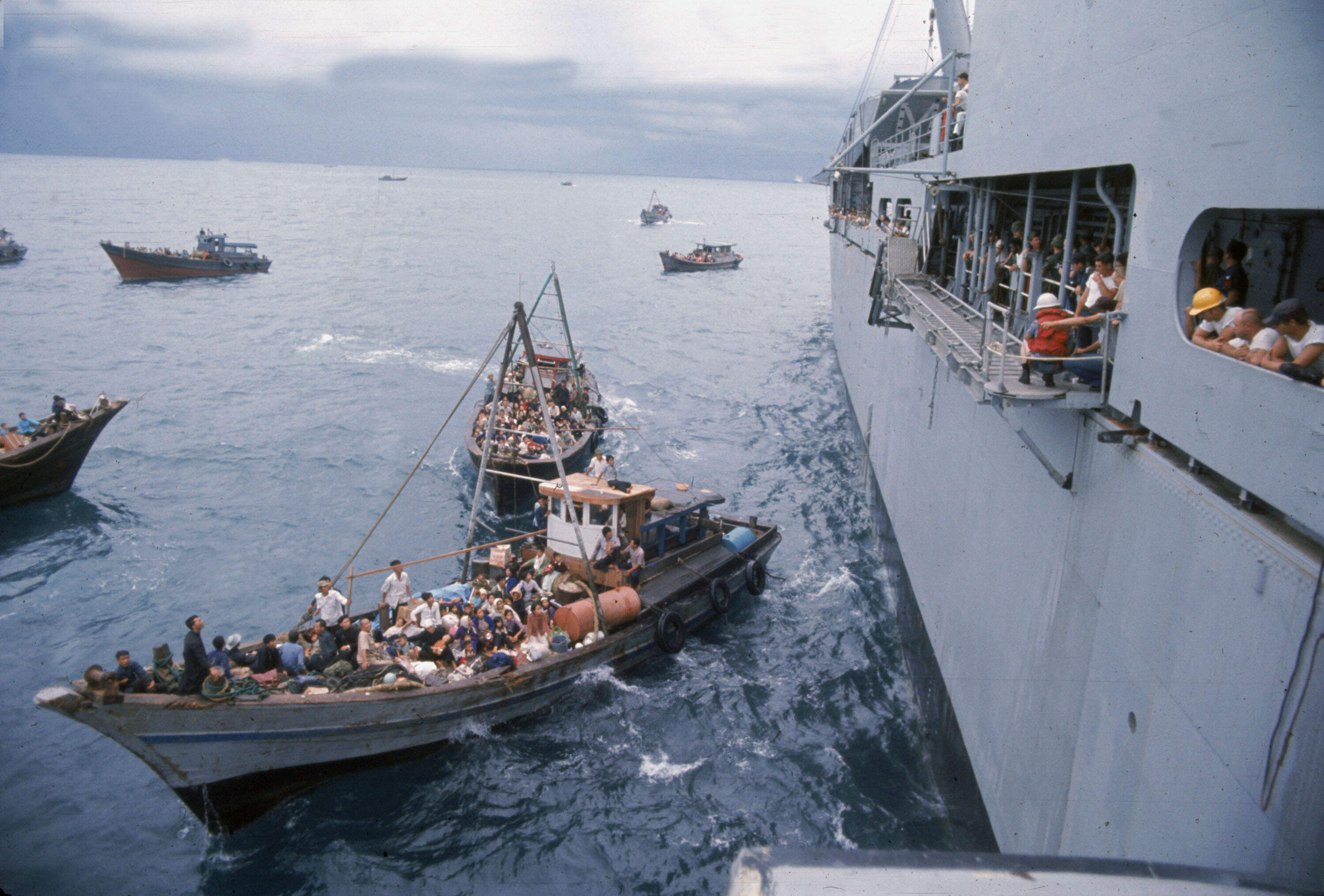 South Vietnamese refugees in boats approach a U.S. war ship to seek refuge from the invading force from the North April 1975 in the South China Sea near Saigon. (Dirck Halstead/Getty Images)