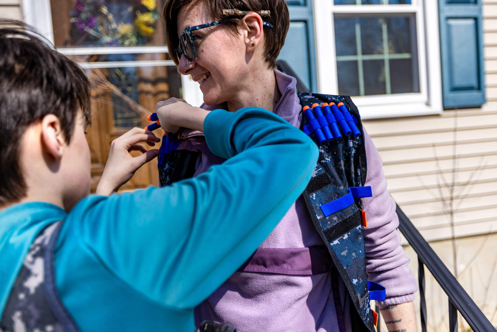 Rosie gets loaded up with Nerf gun ammunition in preparation for a family battle. (Jesse Costa/WBUR)