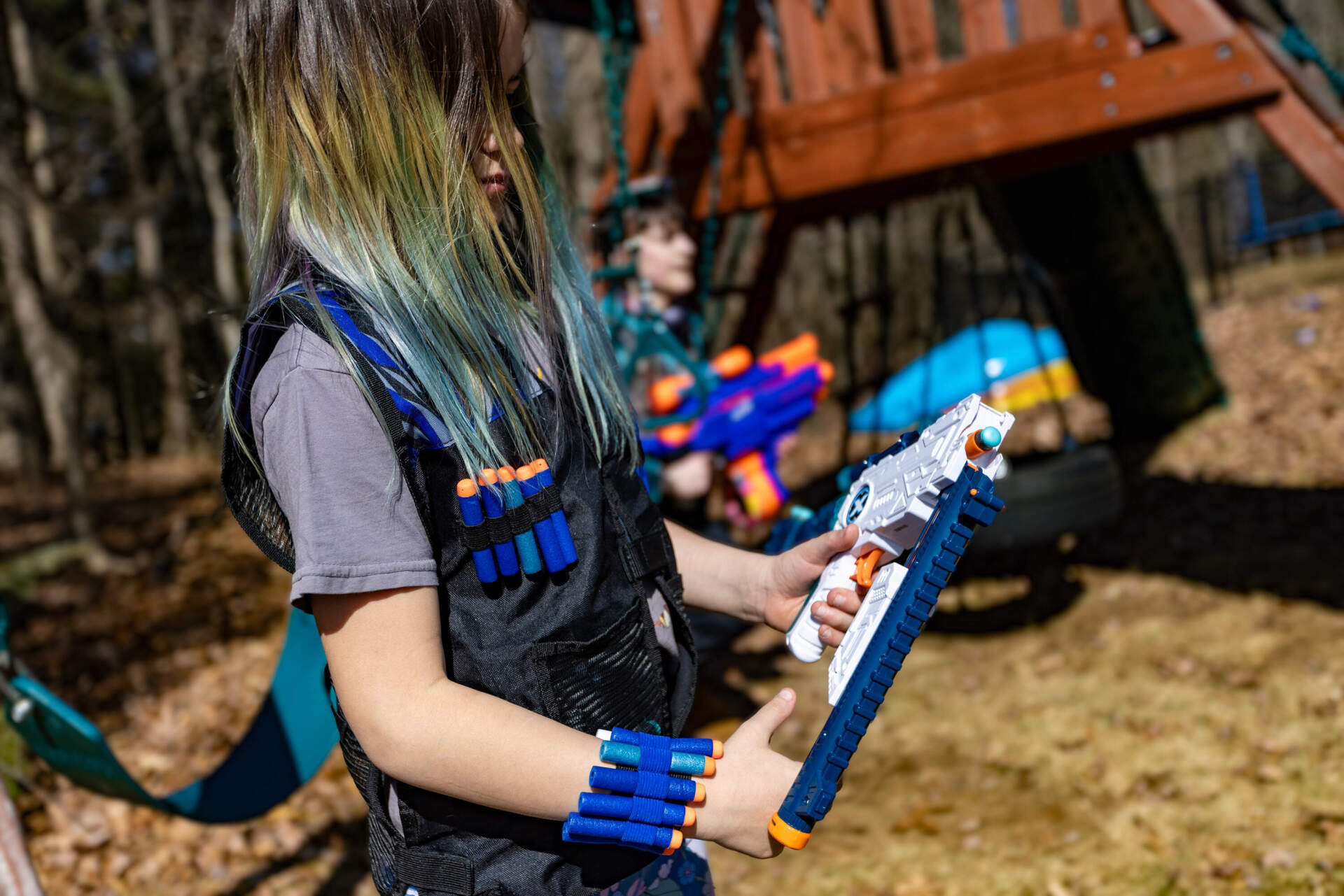 Emily loads a Nerf gun, preparing for a family battle. (Jesse Costa/WBUR)