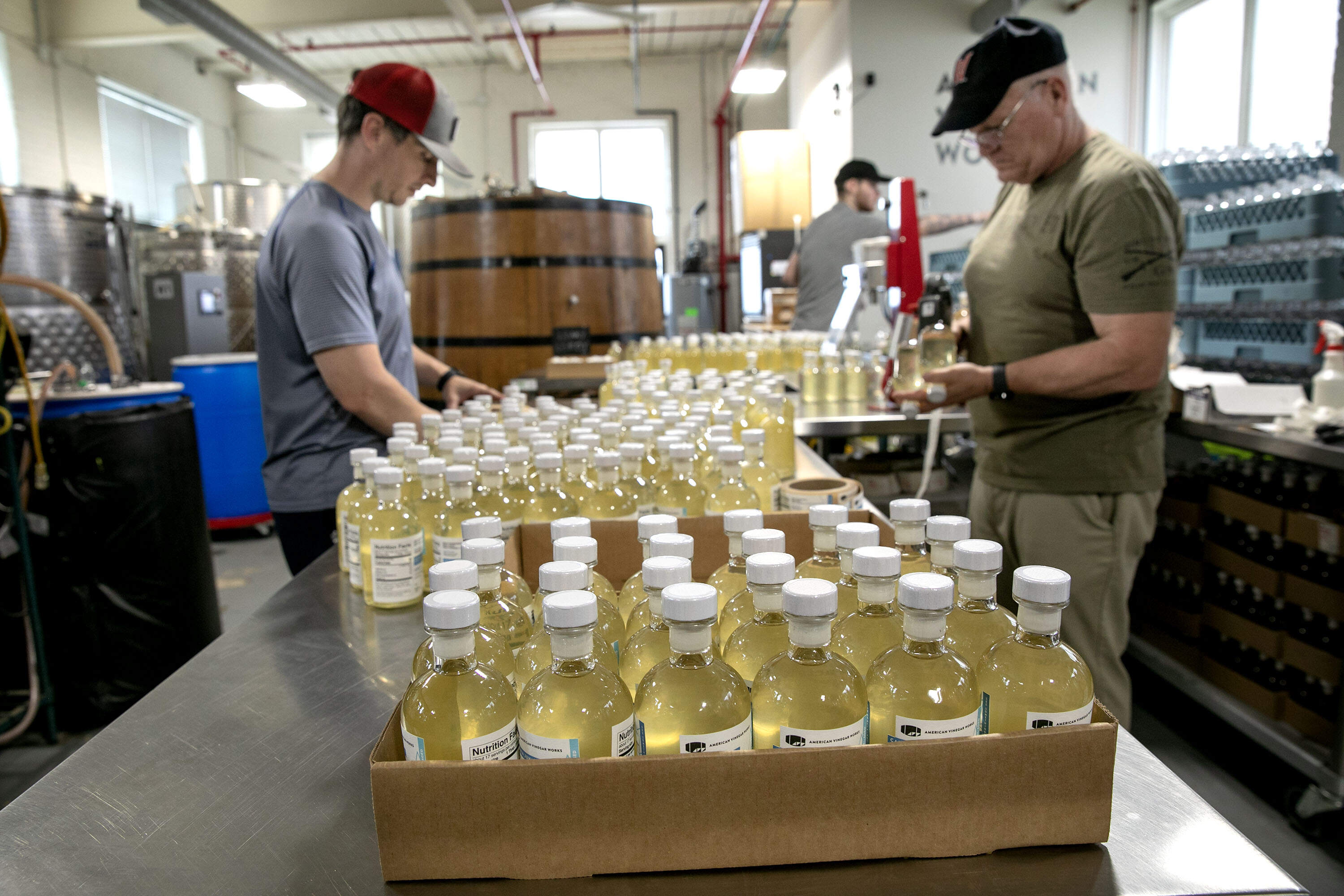 Vinegar bottles on the production line at American Vinegar Works in Worcester. (Robin Lubbock/WBUR)