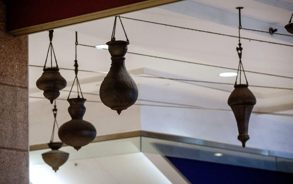 Bronze vessels hanging from the ceiling of Boston's South Station as part of Destinations, a sculpture by artist Jeffrey Schiff. (Robin Lubbock/WBUR)