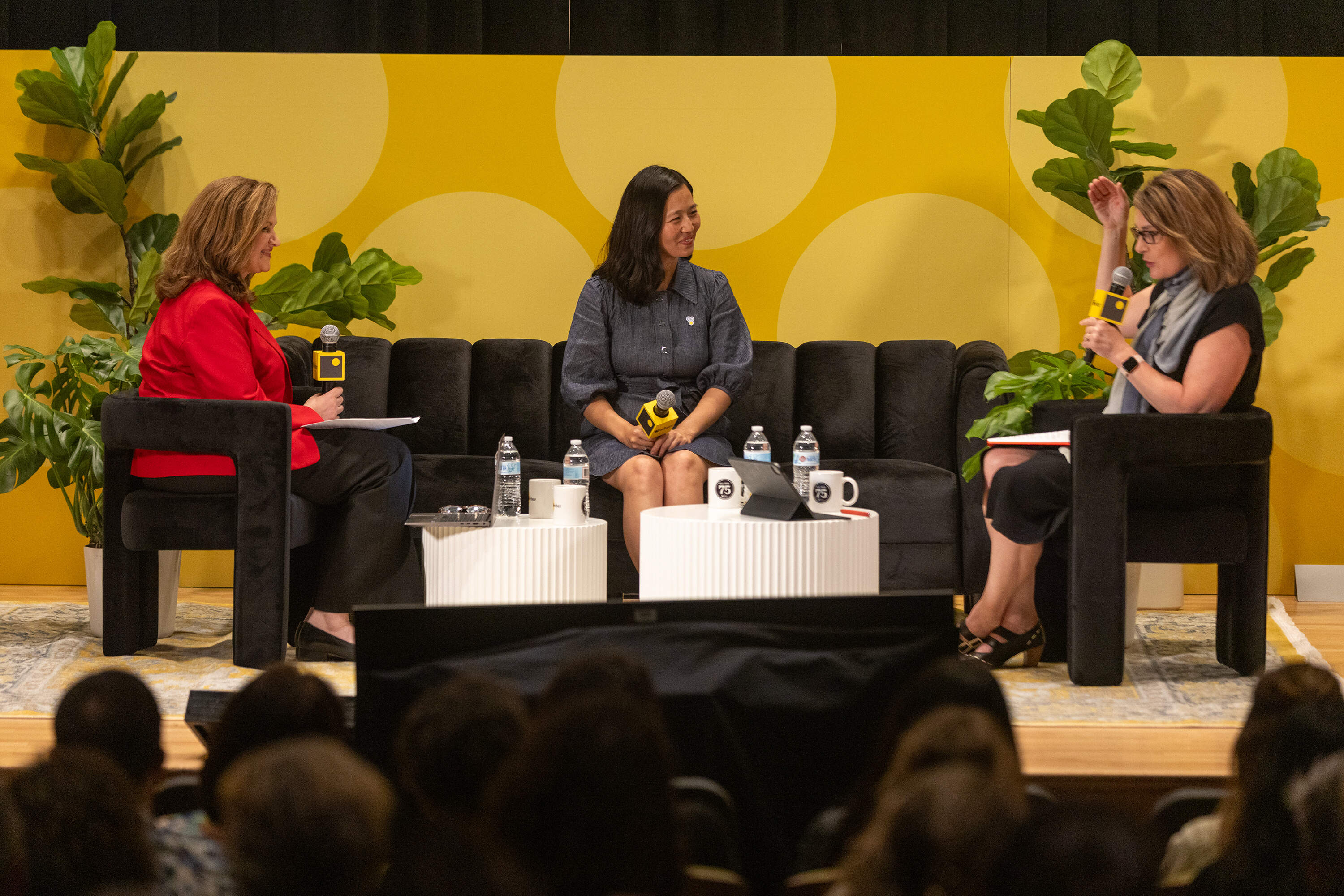 WCVB reporter Sharman Sacchetti, Boston Mayor Michelle Wu and WBUR Morning Edition host Tiziana Dearing on stage during the Conversation with Mayor Wu session at the WBUR Festival. (Jesse Costa/WBUR)