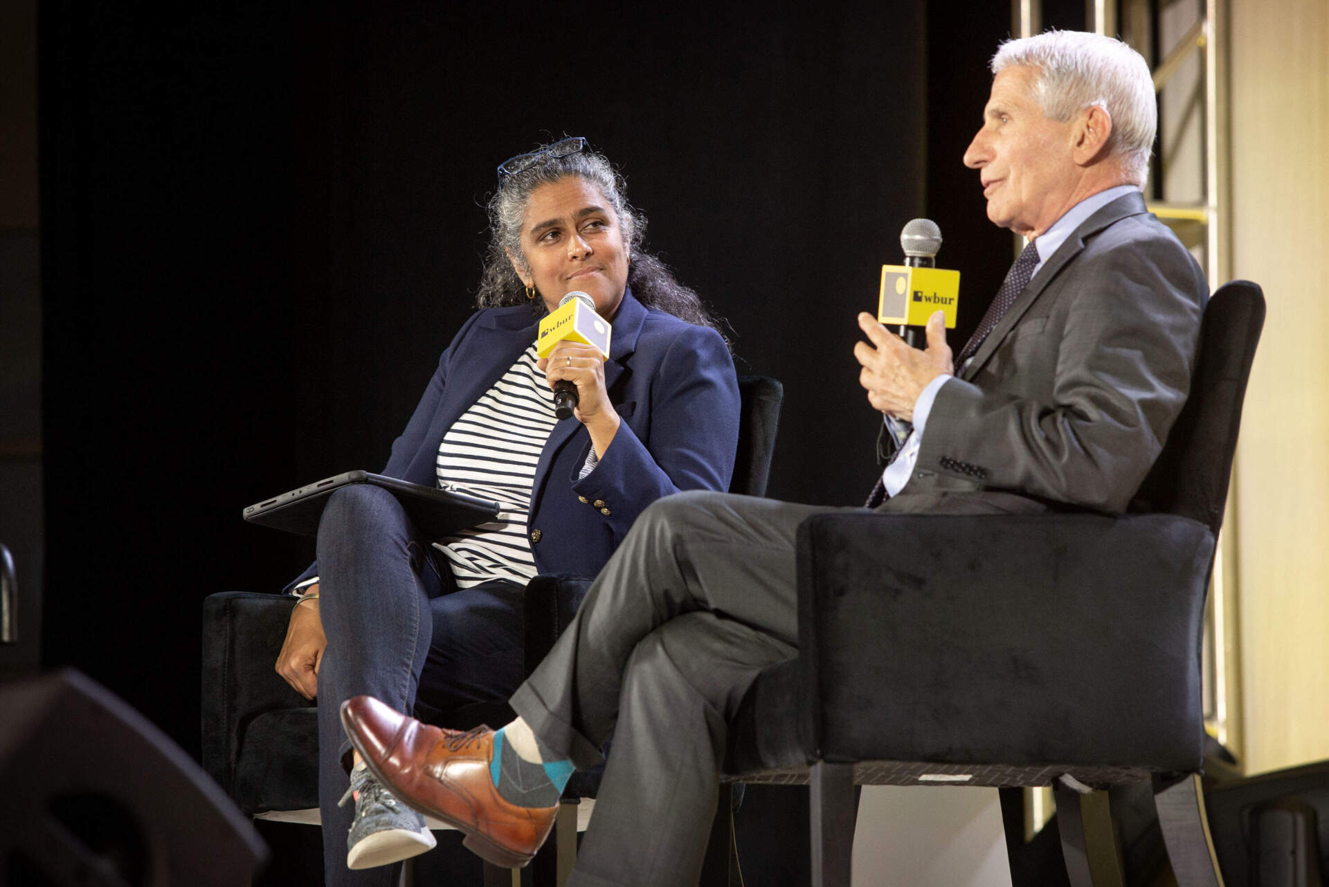 On Point's host Meghna Chakrabarti talks with Dr. Anthony Fauci at The WBUR Festival in Boston. (Robin Lubbock/WBUR)