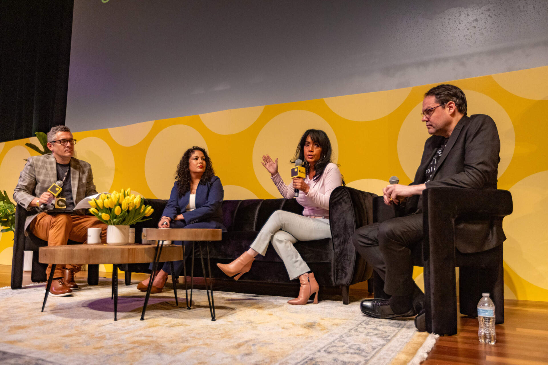 Gladys Vega, the president of La Colaborativa, speaks during a panel moderated by WBUR's Simón Rios. (Jesse Costa/WBUR)