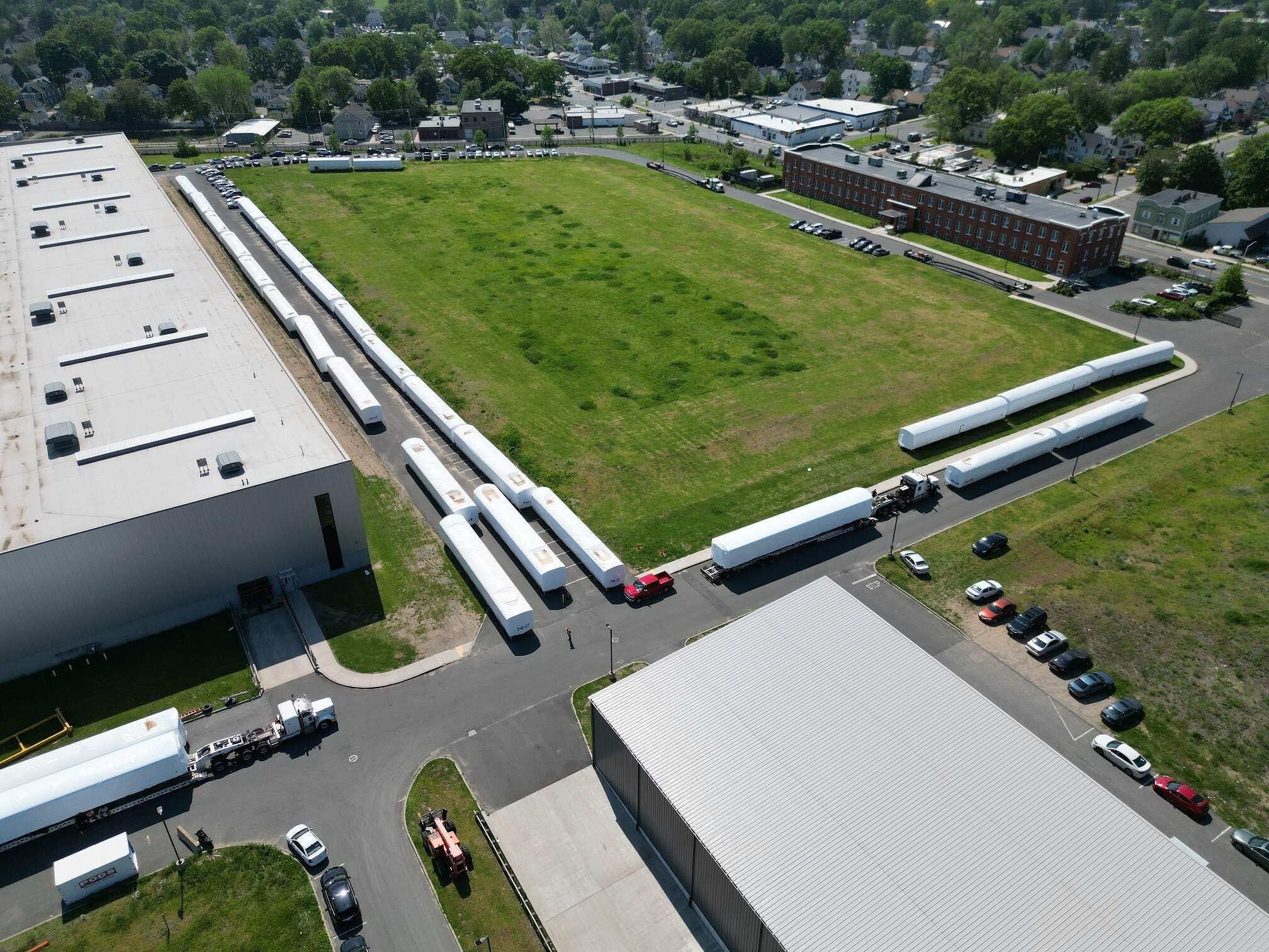 White-wrapped trains sit in a line at the CRRC's facility in Springfield. (Courtesy of the MBTA)