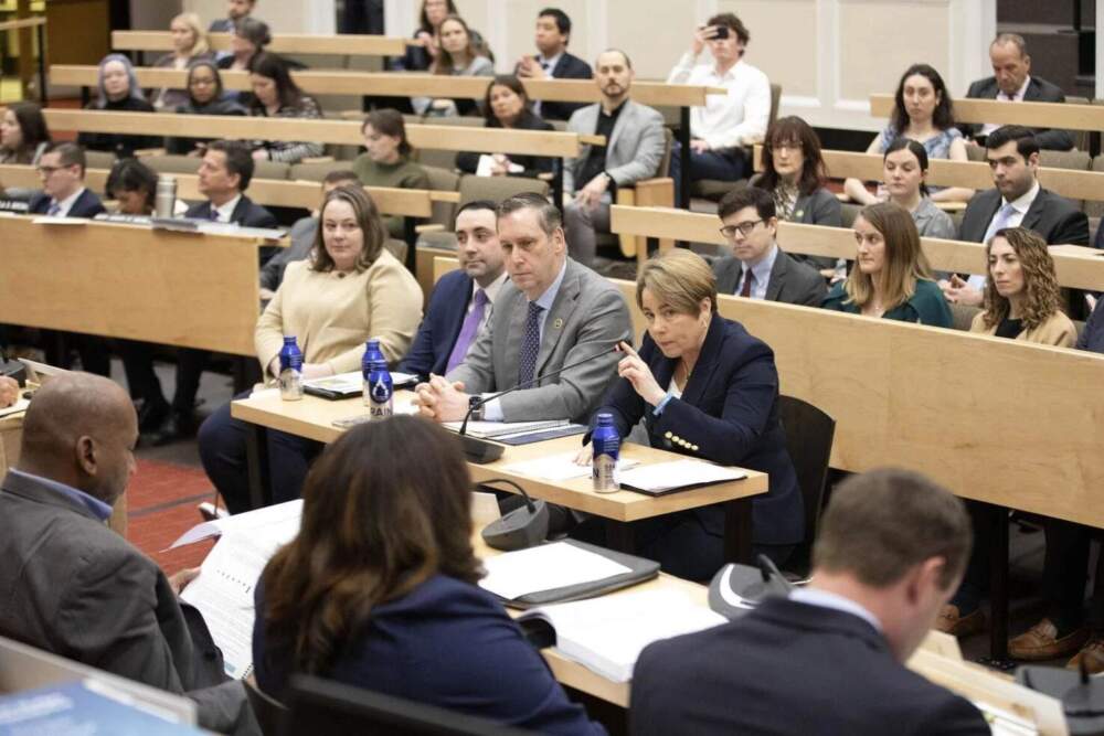 Gov. Maura Healey (right) and Administration and Finance Secretary Matthew Gorzkowicz (second from right) address lawmakers at a March 6, 2025 hearing about their fiscal 2026 budget proposal. (Chris Lisinski/SHNS)