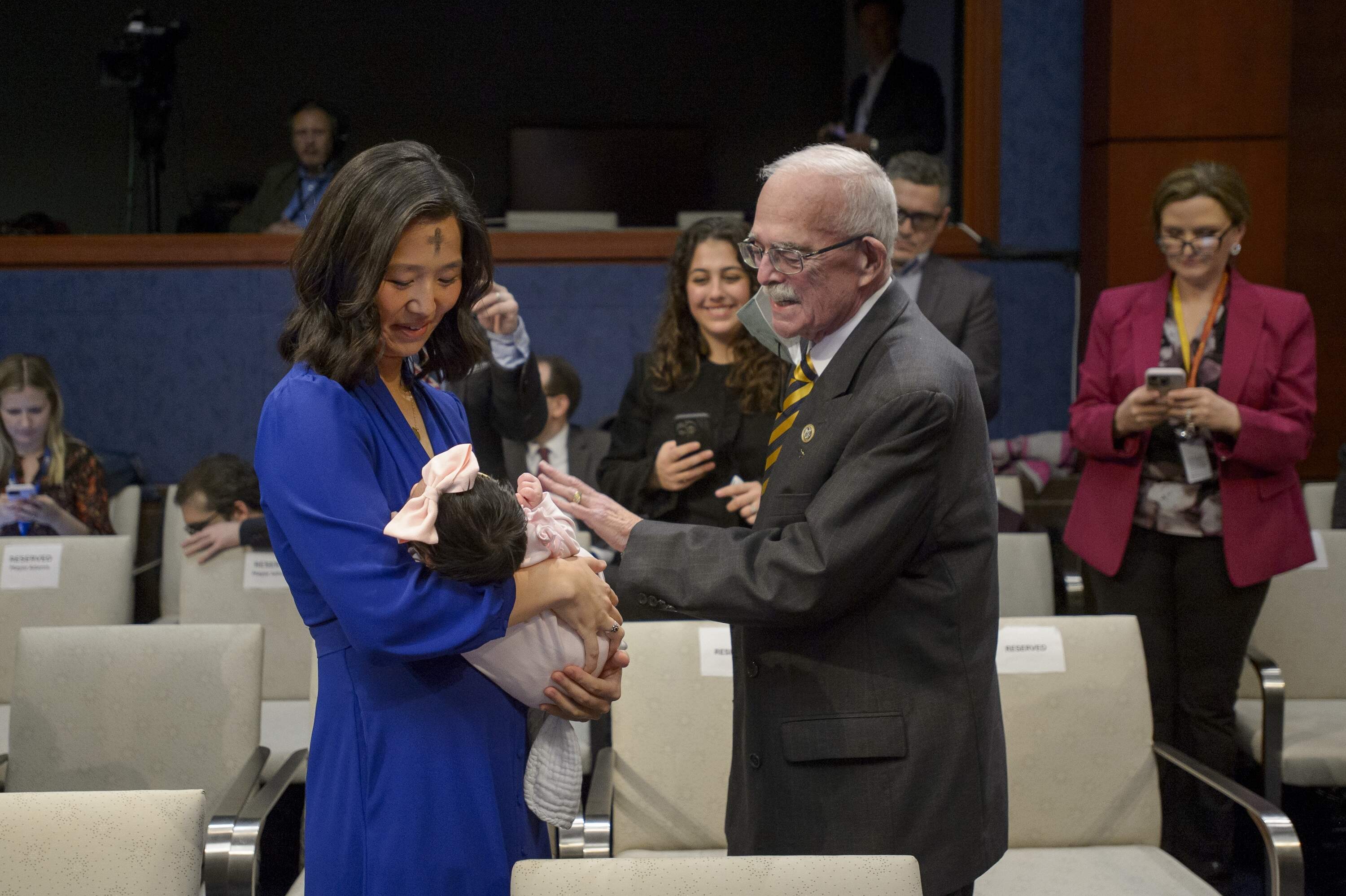 Boston Mayor Michelle Wu shows off her daughter Mira to Rep. Gerry Connolly, D-Va., during a House Committee on Oversight and Government Reform hearing March 5, 2025, in Washington. (Rod Lamkey, Jr./AP)