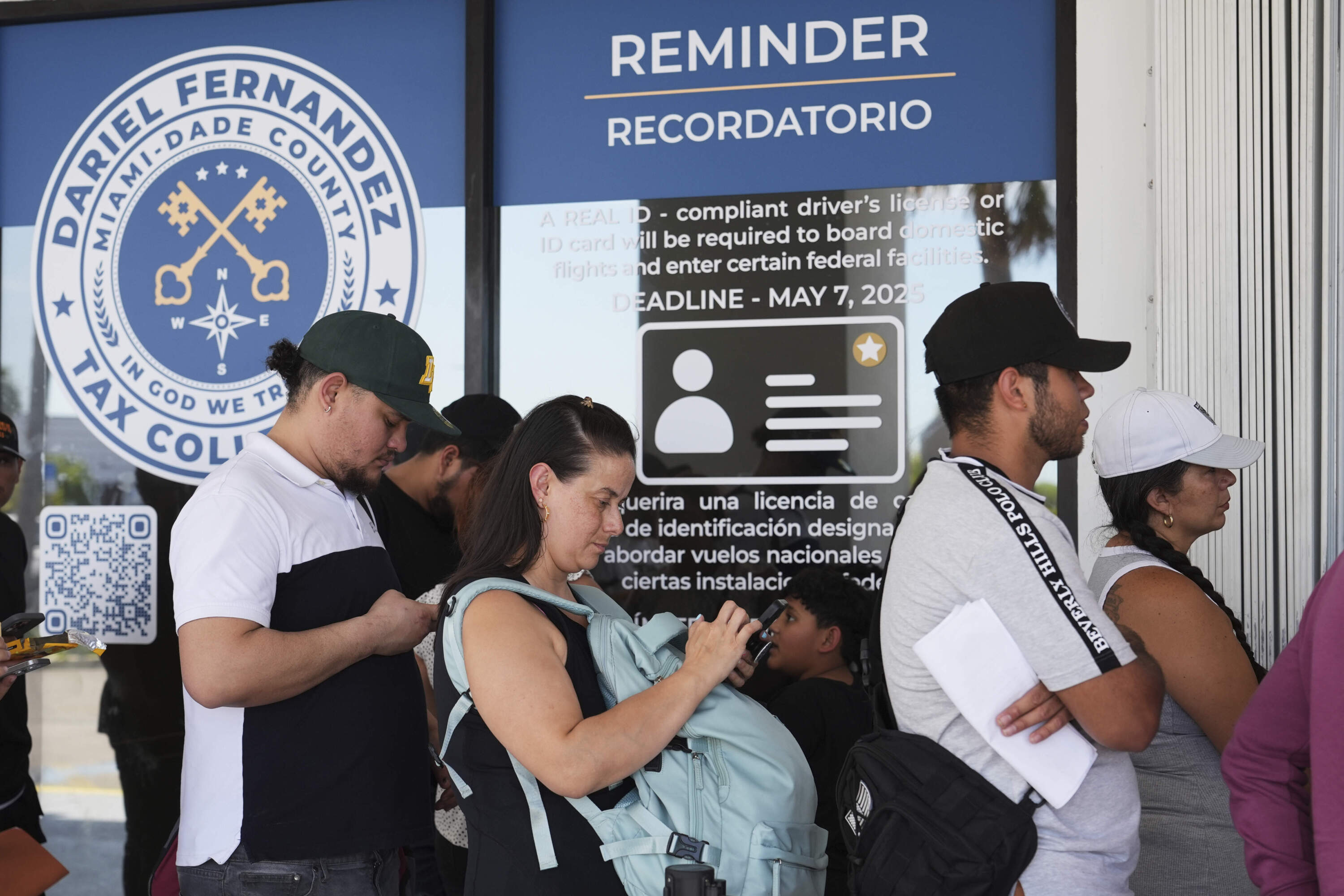 People stand in line outside of a Miami-Dade County Office of the Tax Collector Tuesday, May 6, 2025, in Miami. (Lynne Sladky/AP)