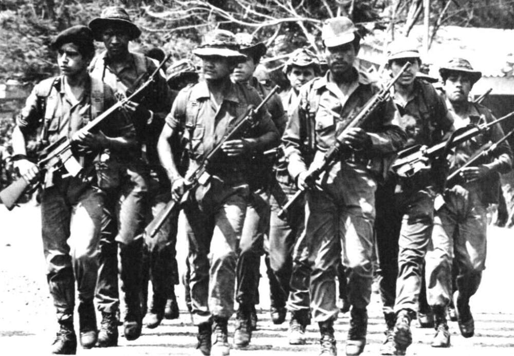 A group of soldiers from the Salvadoran army's 3rd brigade, march in formation at their fort in San Miguel, in the eastern part of El Salvador, April 14, 1984. The fort is one of the areas where troops are trained by U.S. military advisers. the area north of San Miguel has been the scene of much fighting lately. (Luis Romero/AP)