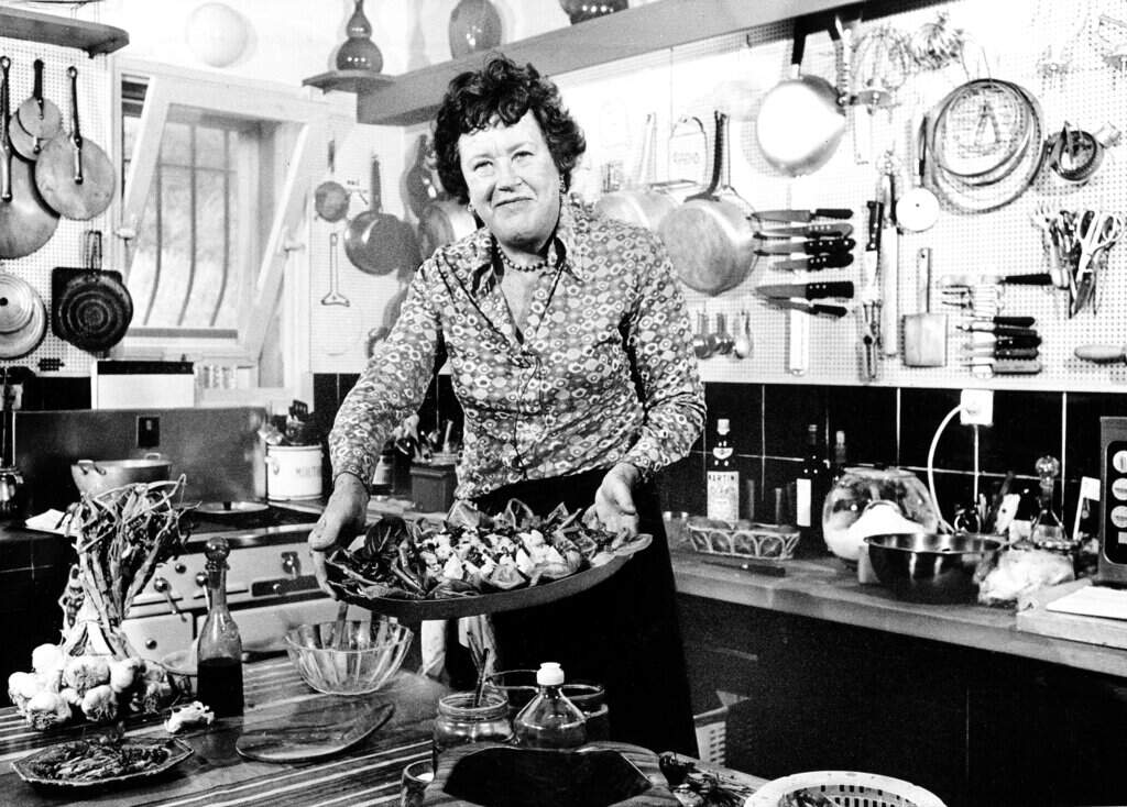 Chef Julia Child displays a salad nicoise she prepared in the kitchen of her vacation home in Grasse, southern France, in 1978. (AP)