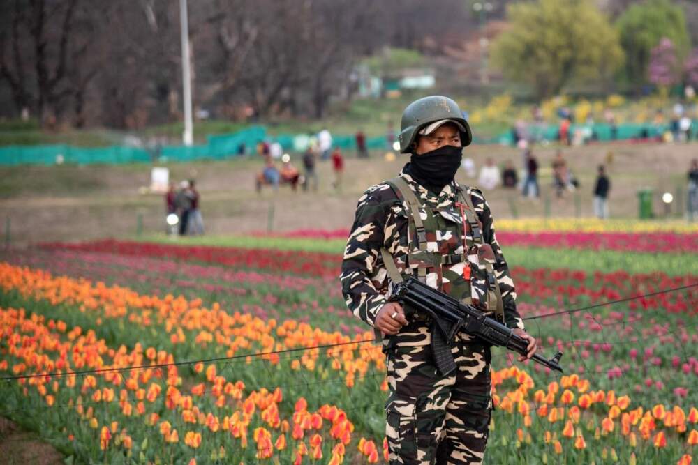 An Indian paramilitary trooper keeps vigil inside the Tulip Garden during a sunny spring day in Srinagar in 2021. (SOPA Images/LightRocket/Getty)