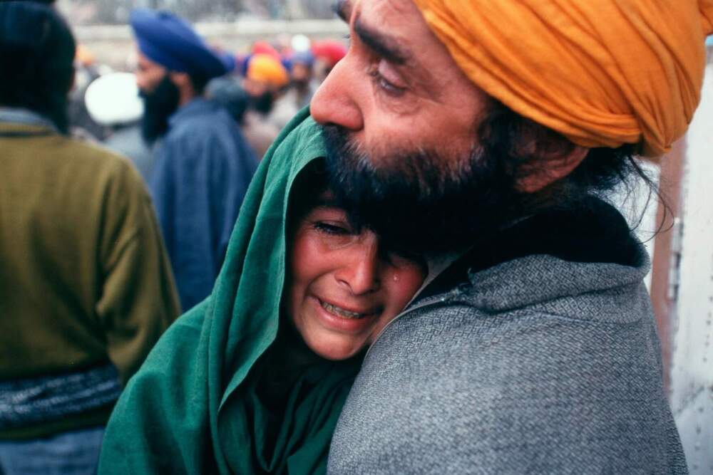 Families grieve after 36 men in a small Sikh community in the Chittisinghpora Village, Kashmir Valley were massacred by two foreign militants, coinciding with Bill Clinton's visit to India, March 21, 2000. The killings marked the first time that militants targeted the minority Sikh community of Kashmir. (Robert Nickelsberg/Getty)