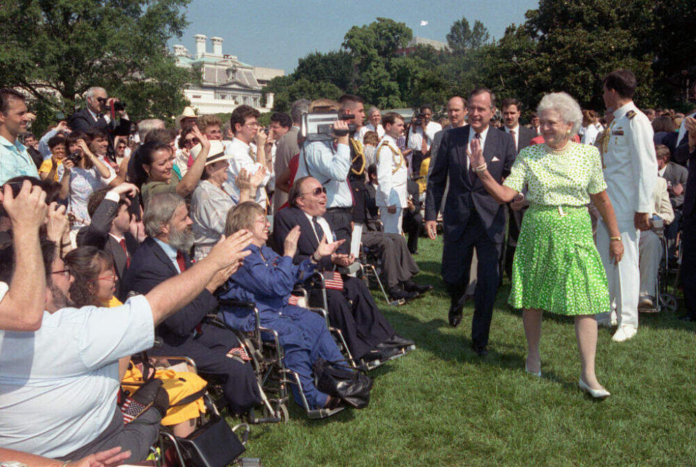 President George Bush and First Lady Barbara Bush receive applause by some of the 2,000 people from major disability groups that gathered to witness the signing of the Americans with Disabilities Act on July 25, 1990. (ADA). (Bettmann/CORBIS via Getty Images)