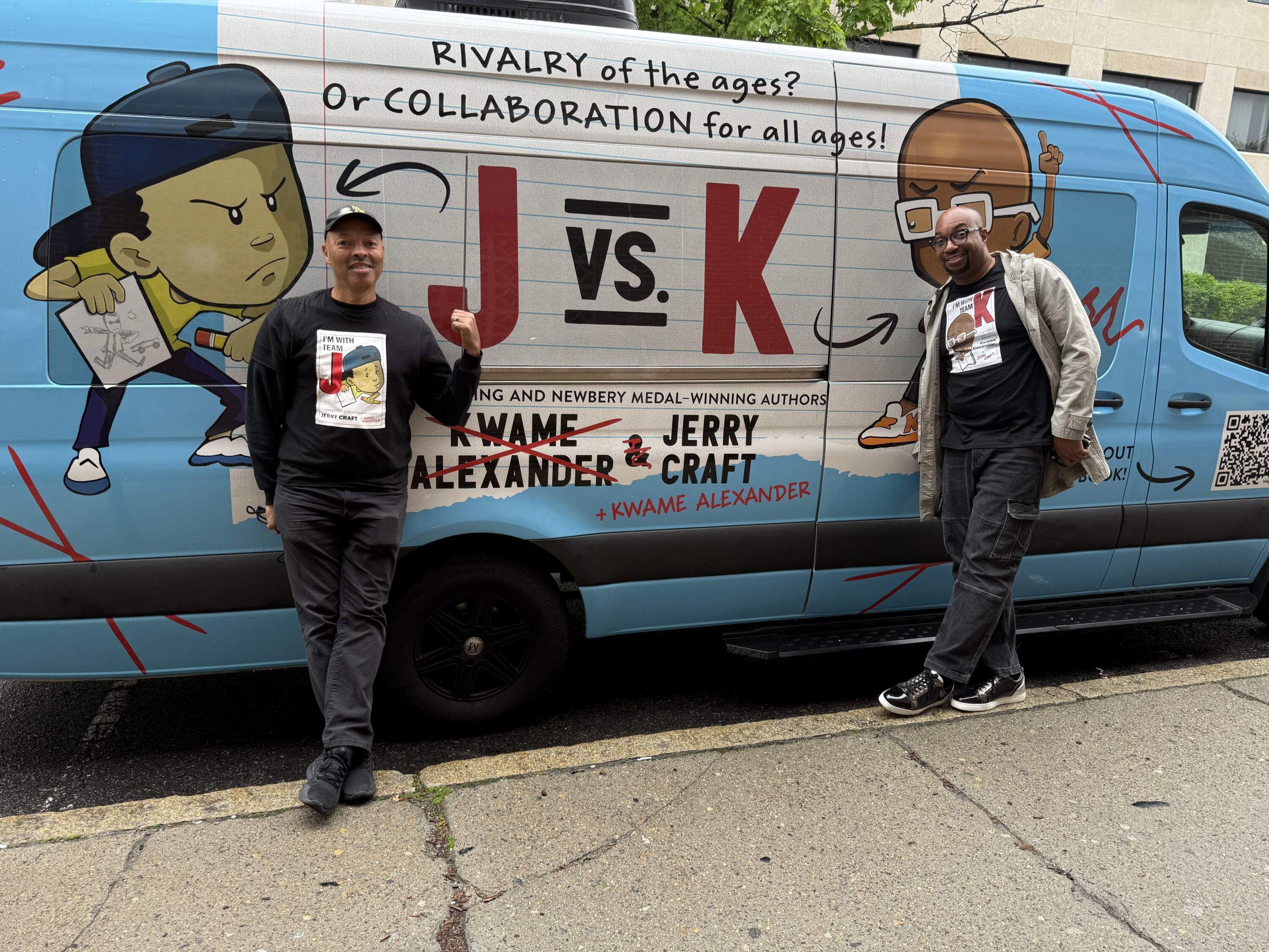 Jerry Craft and Kwame Alexander stand with a van promoting "J Vs. K." (Michael Scotto/Here &amp; Now)