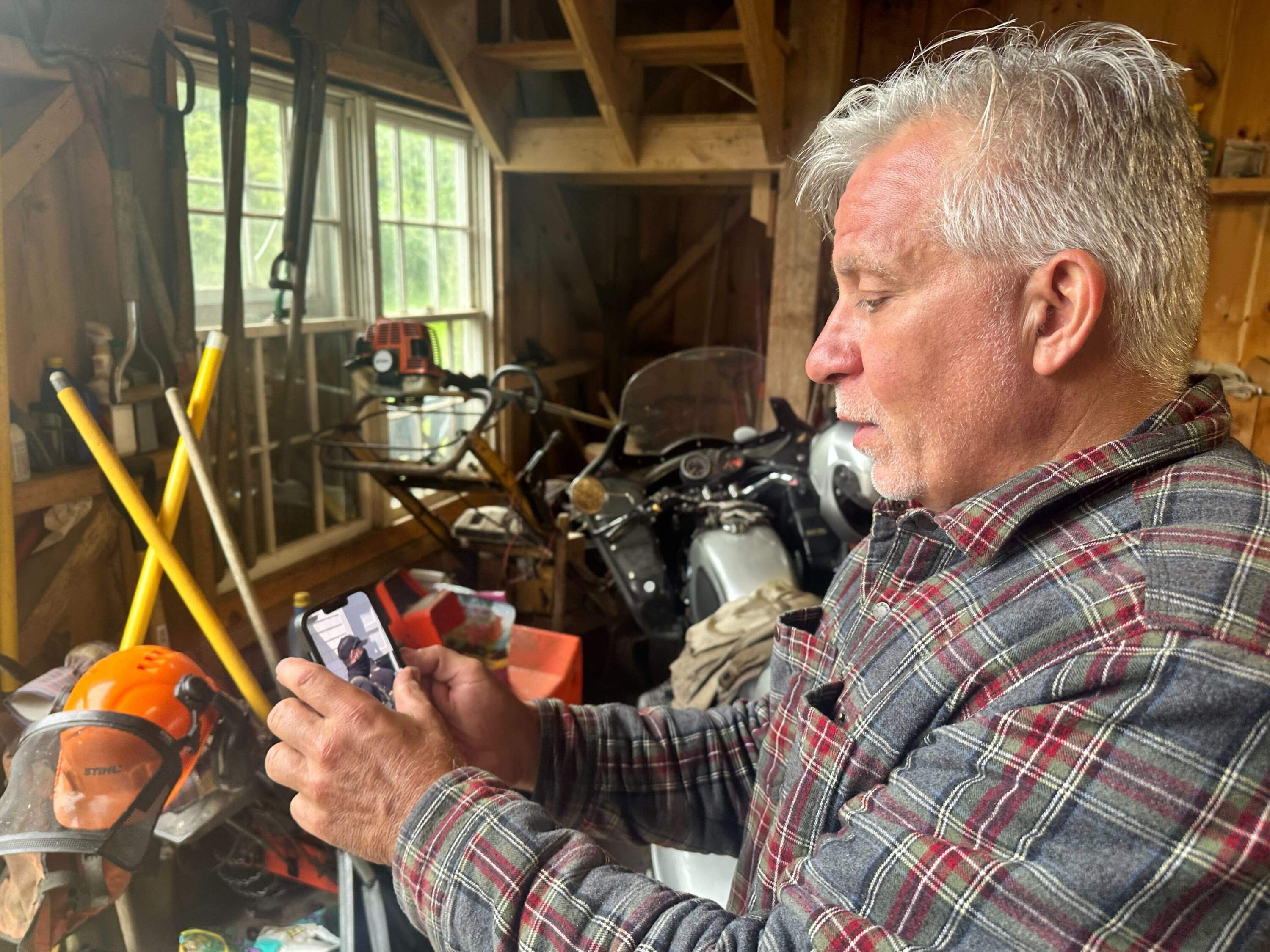 Charlie Giordano shows a video he captured of ICE agents arresting immigrants on Martha's Vineyard. (Simón Rios/WBUR)