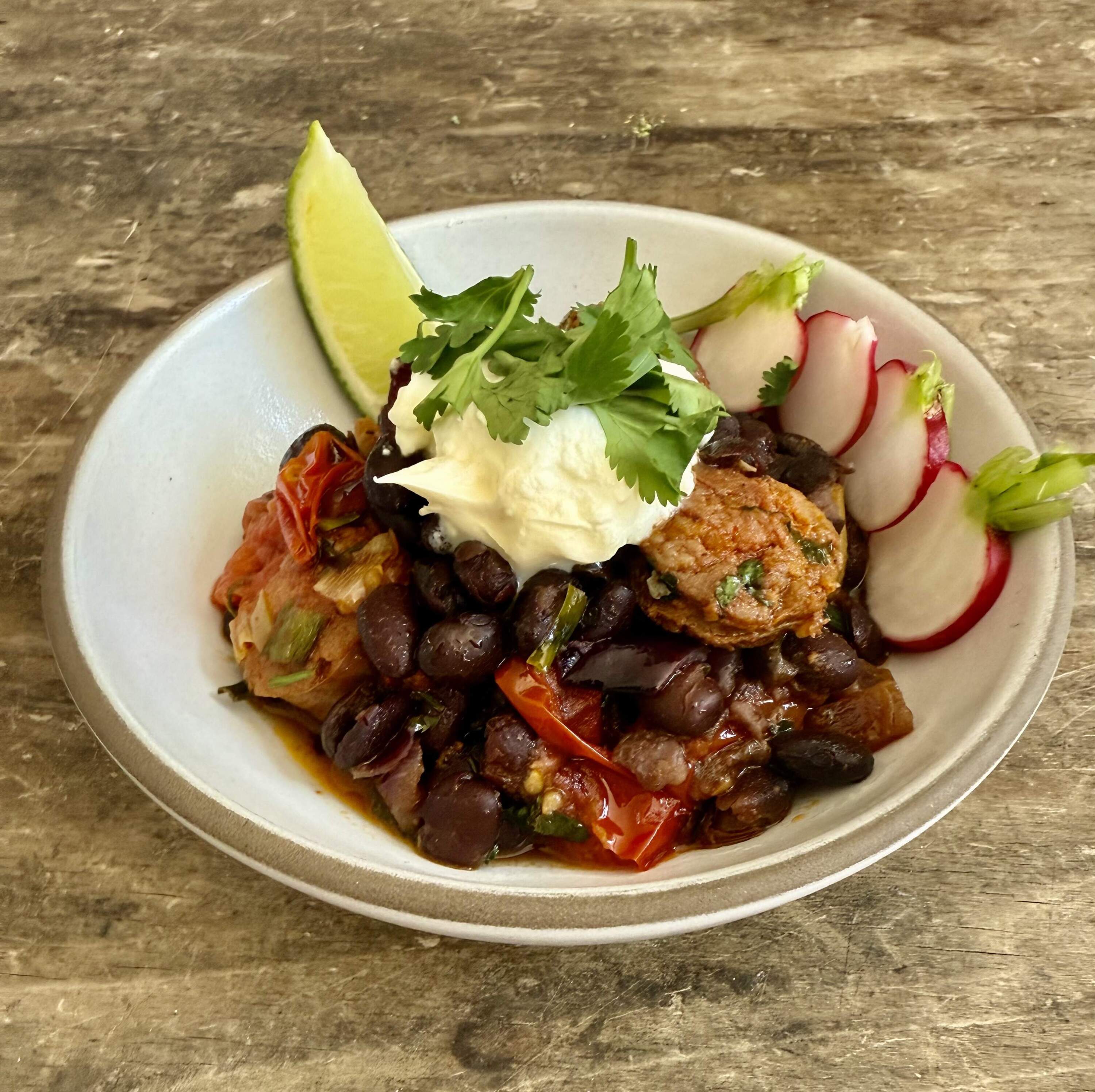 Black beans and chorizo with tortillas, radishes and lime. (Kathy Gunst/Here & Now)