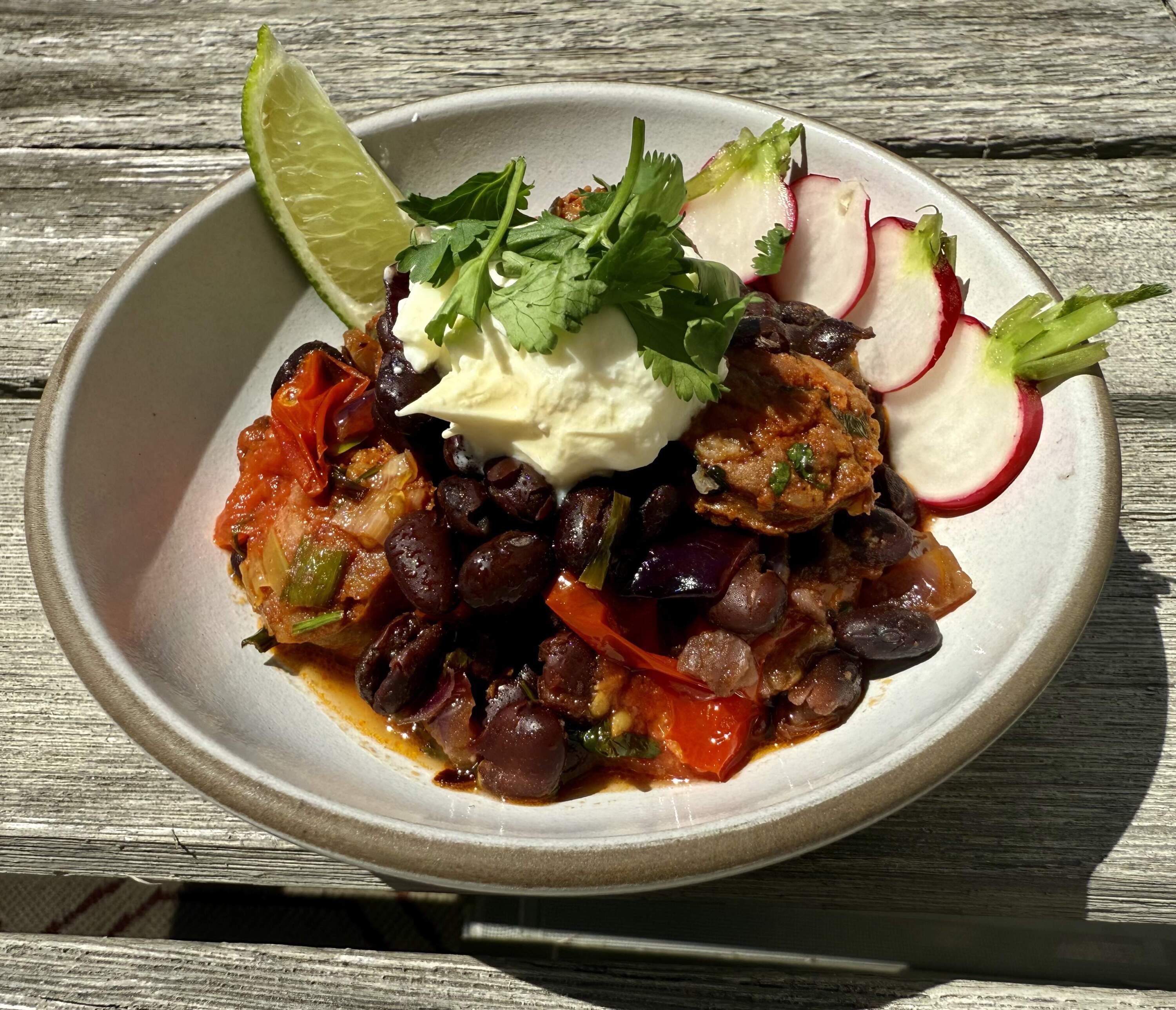Black beans and chorizo with tortillas, radishes and lime. (Kathy Gunst/Here & Now)