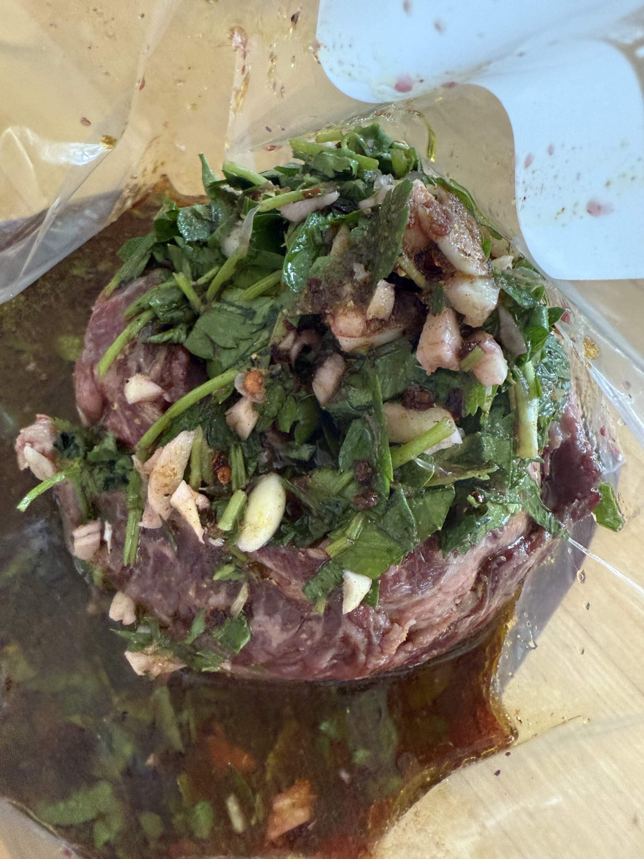 Lime-cumin-chile-red wine marinade/sauce on skirt steak. (Kathy Gunst/Here & Now)