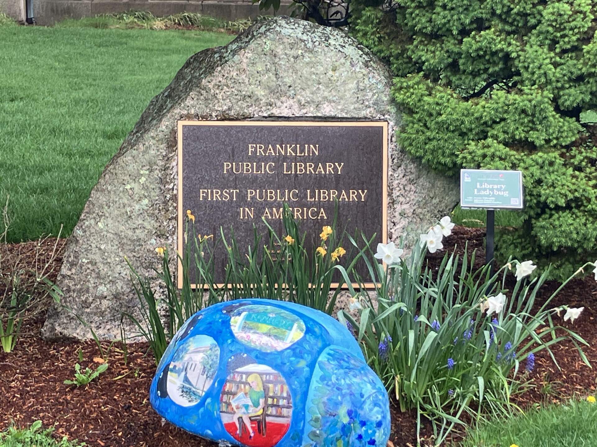 A stone monument outside the Franklin Public Library commemorates its status as the first public library in America (Paul Connearney/WBUR)