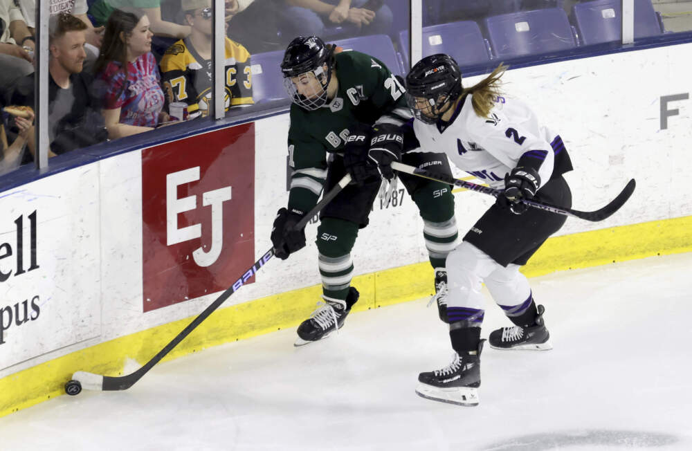 Boston forward Hilary Knight (21) and Minnesota defender Lee Stecklein (2) chase the puck during the first period of Game 2 of a PWHL hockey championship series, Tuesday, May 21, 2024, in Lowell, Mass. (Mark Stockwell/AP)