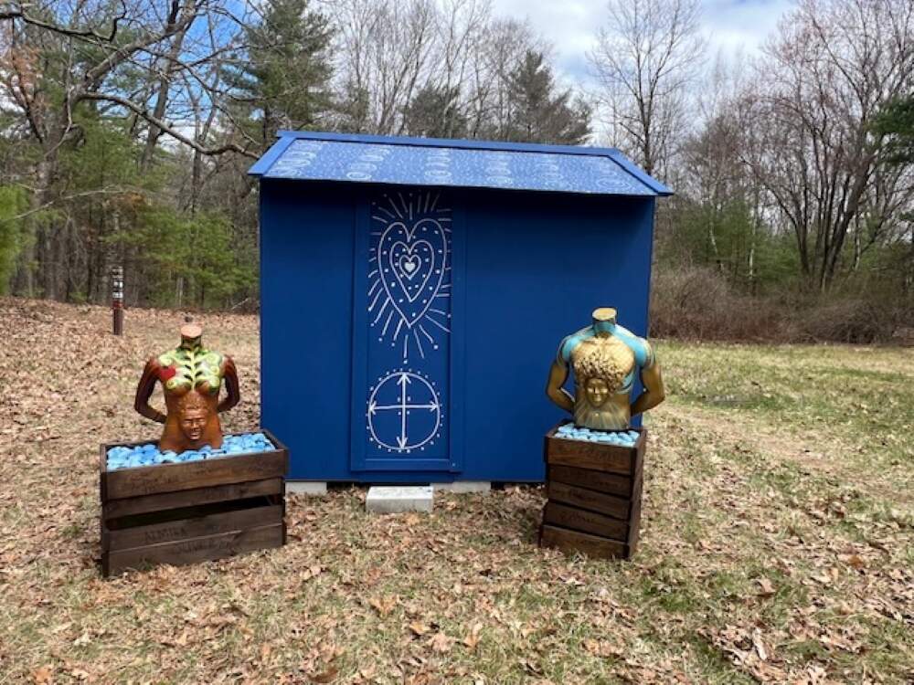 Two of Marla McLeod's mannequin works with Ifé Franklin's "Slave Cabin" installed at Brister's Hill. (Jacquinn Sinclair/WBUR)