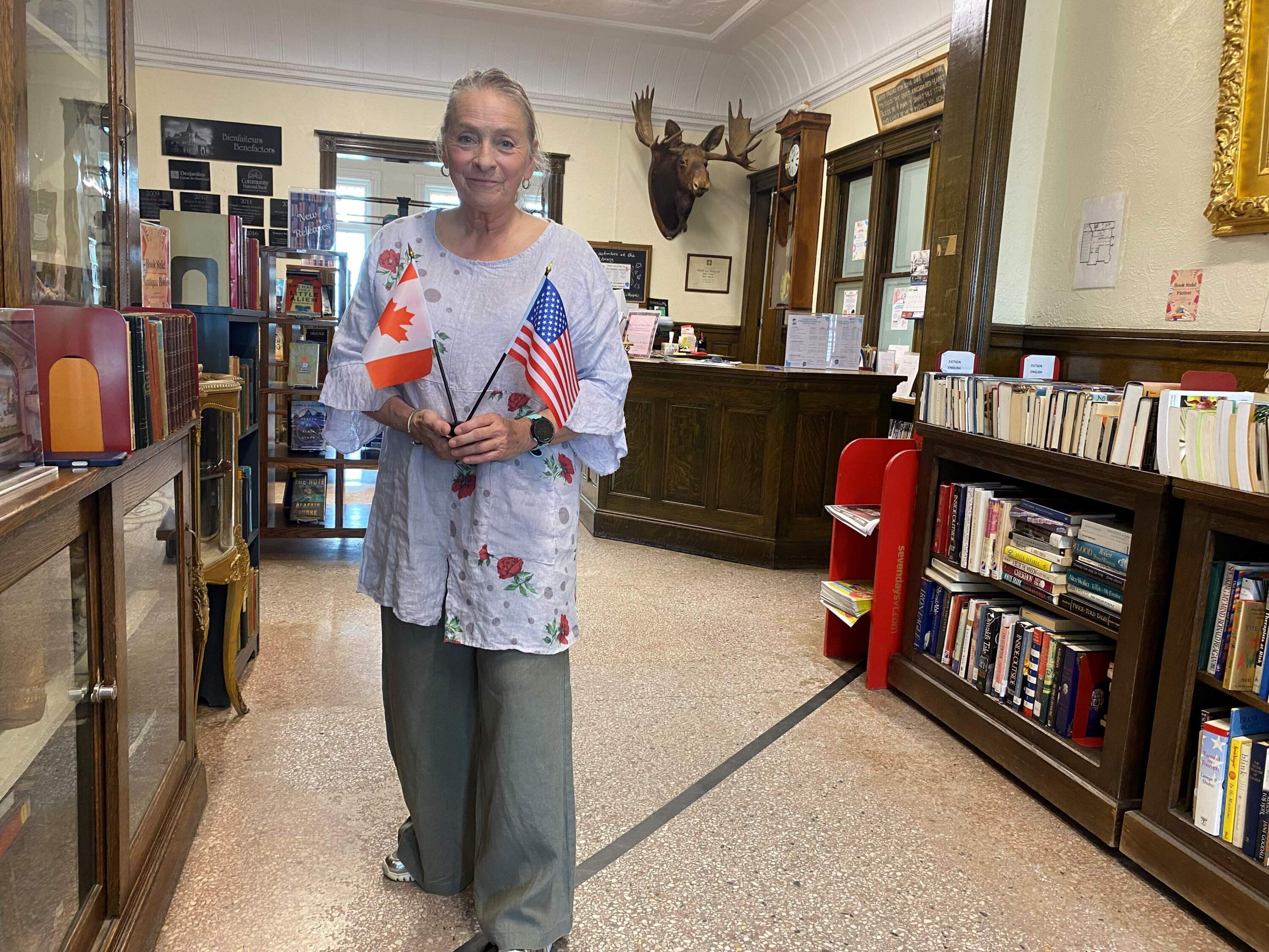 Sylvia Boudreau, President of the Board of Trustees, stands on the border line inside the Haskell Frell Library &amp; Opera House (Anthony Brooks/WBUR)
