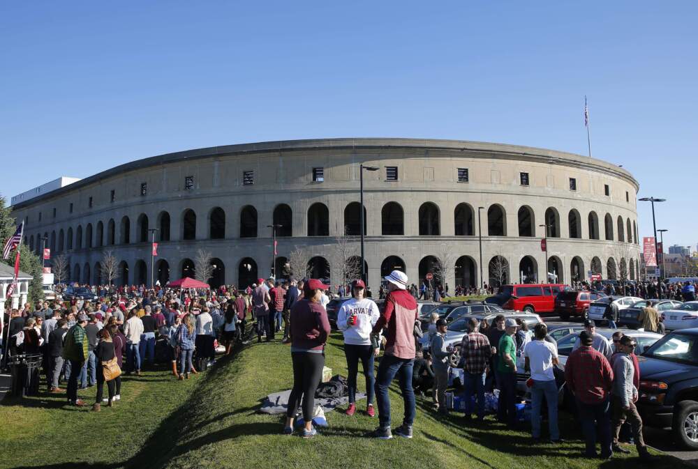 Tailgaters gather outside Harvard Stadium before a football game between Harvard and Yale in 2016. (Winslow Townson/AP)