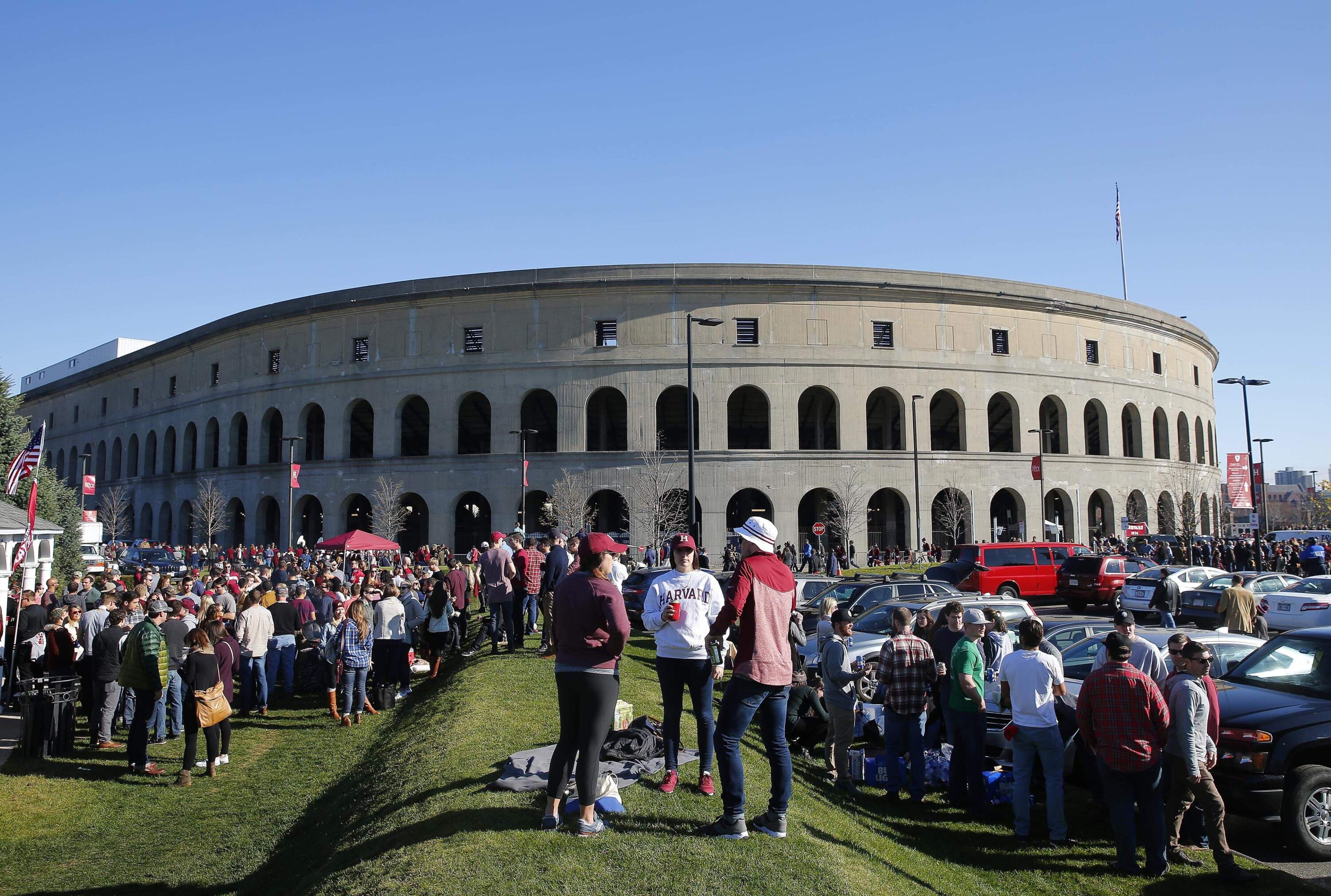 Tailgaters gather outside Harvard Stadium before a football game between Harvard and Yale in 2016. (Winslow Townson/AP)