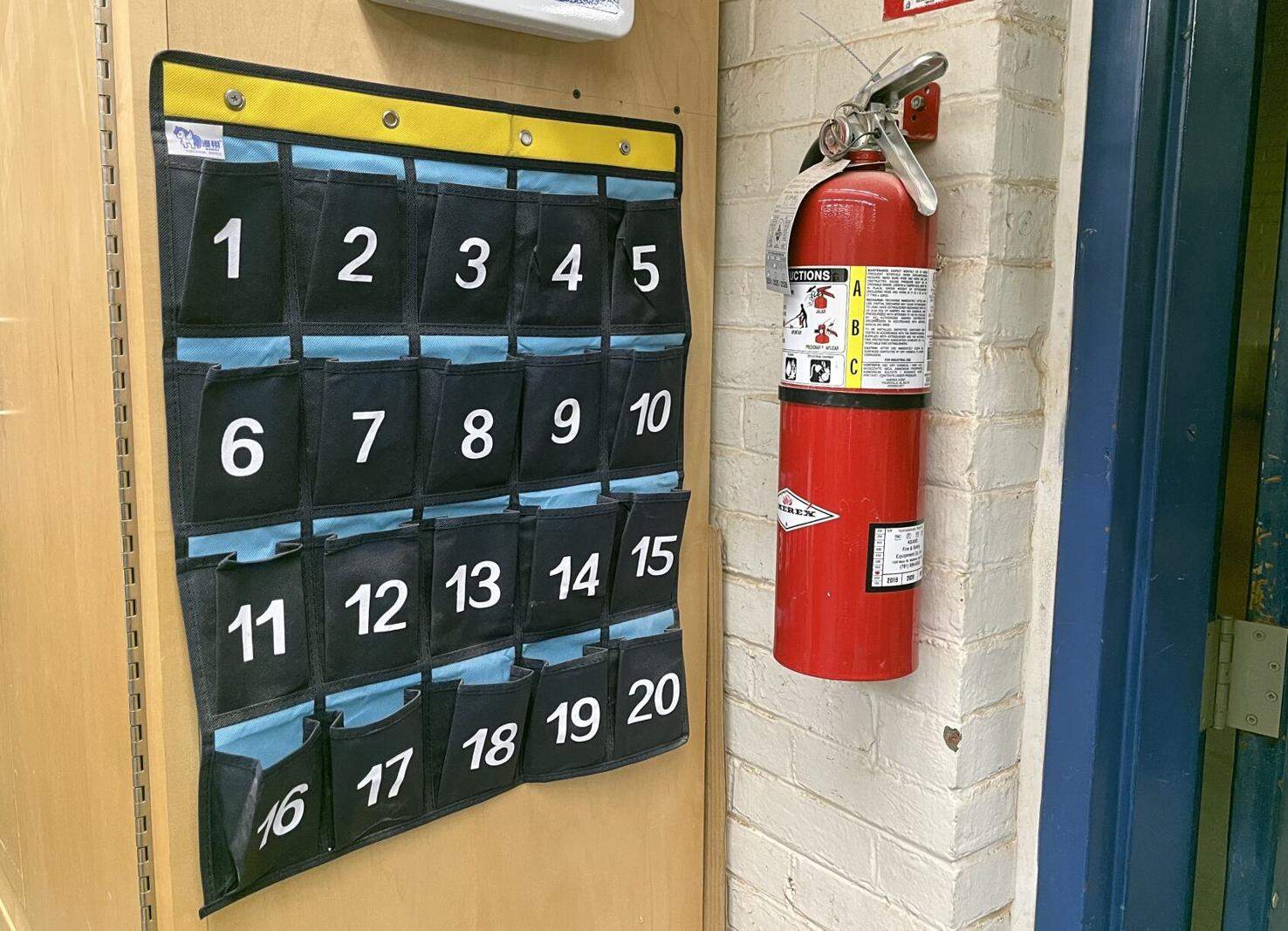 A numbered cellphone holder hangs in a classroom in Brookline High School. (SHNS)