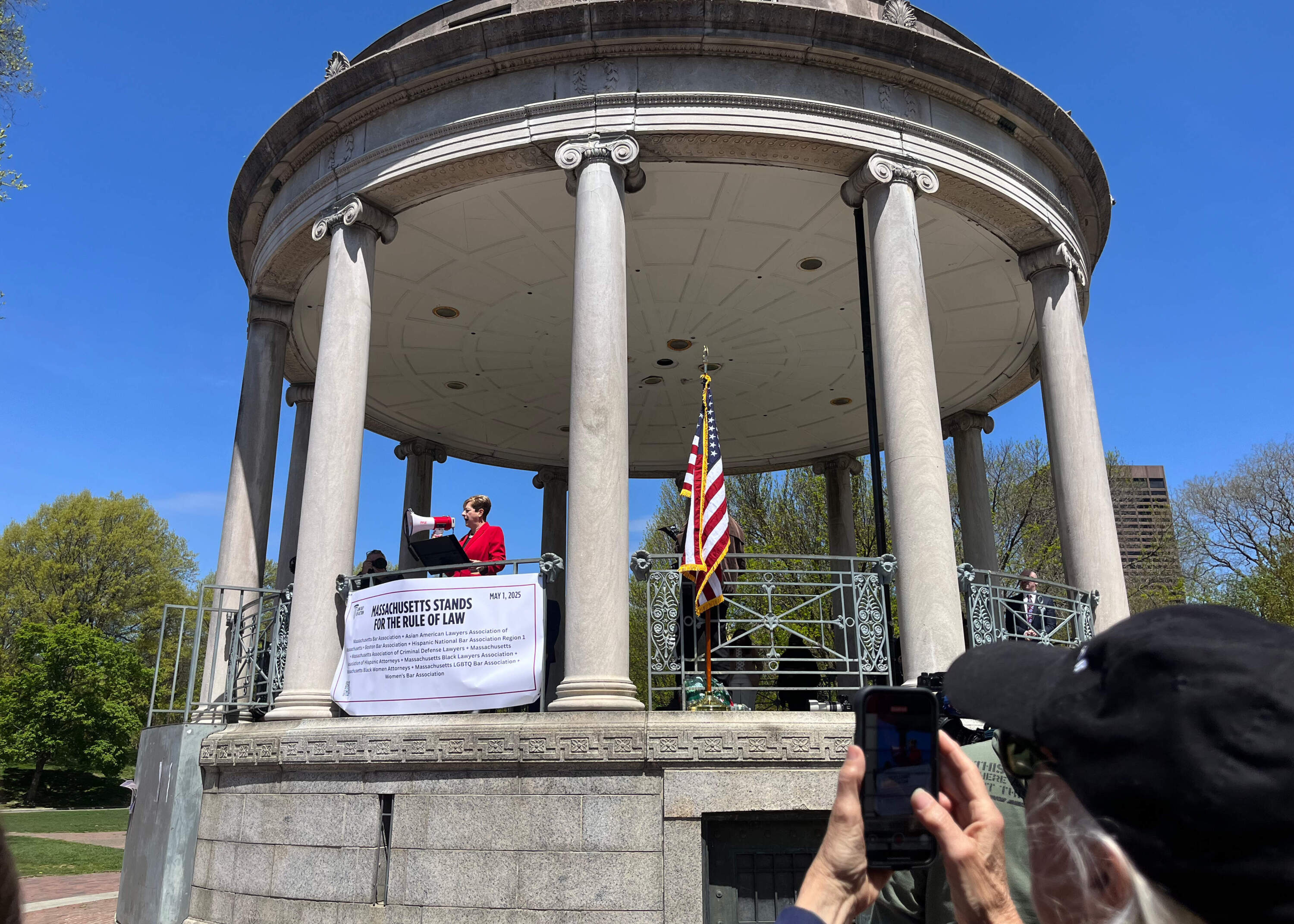 Former Supreme Judicial Court Clerk for Suffolk County Maura Doyle speaks to a crowd at the National Law Day of Action protest. (Chloe Jad/WBUR)