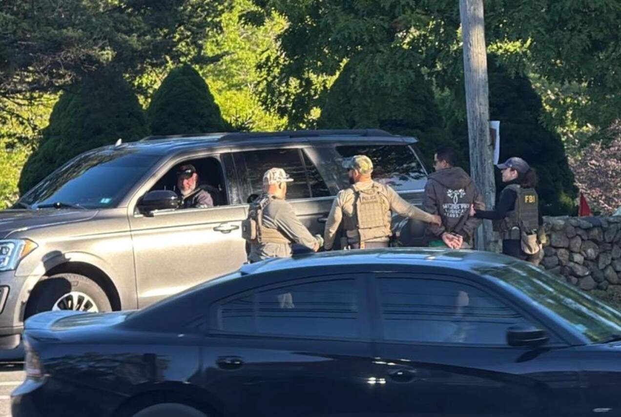 Officers take a man into custody in Vineyard Haven Tuesday. (Vineyard Gazette)