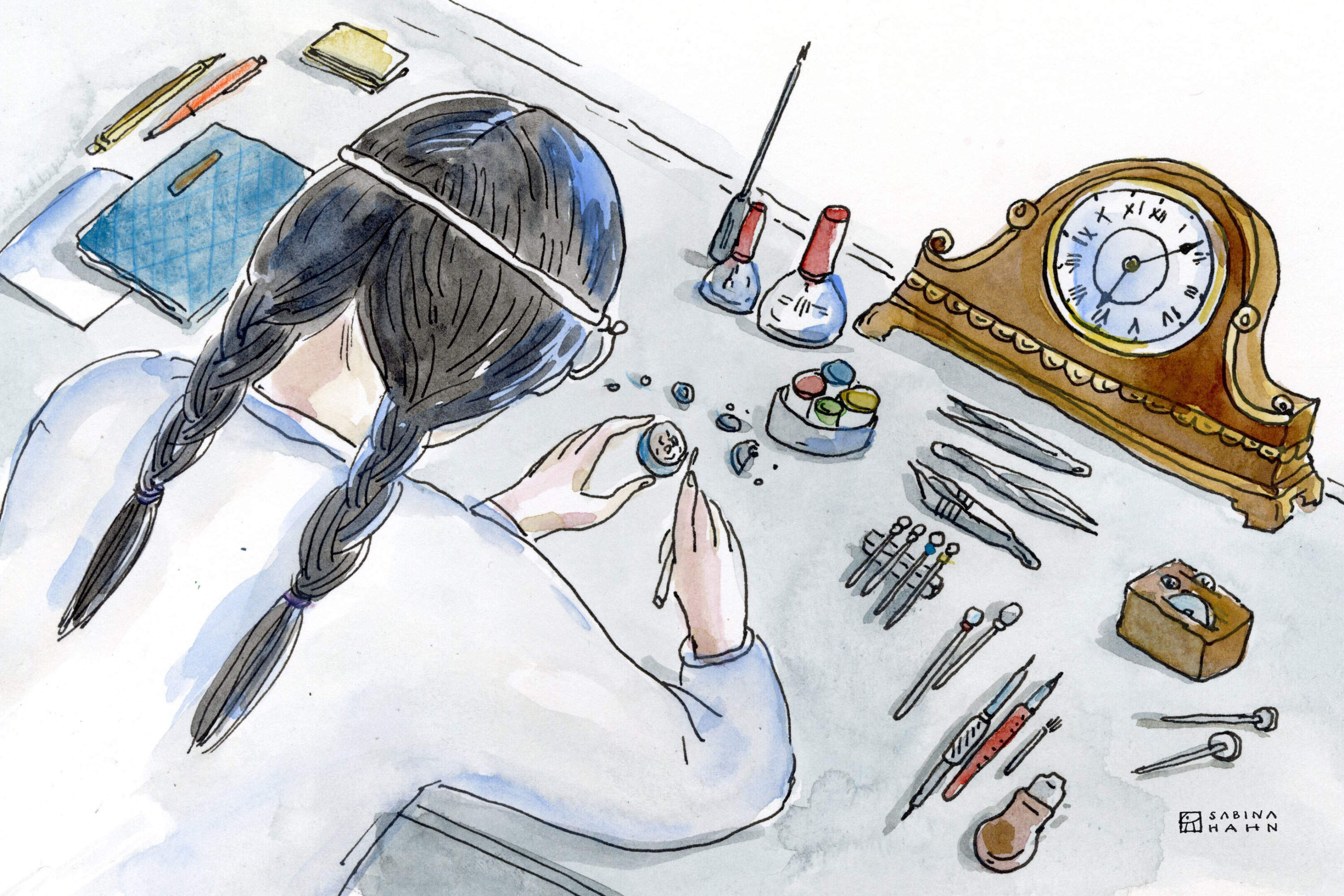 A person working on a clock. (Sabina Hahn for WBUR)
