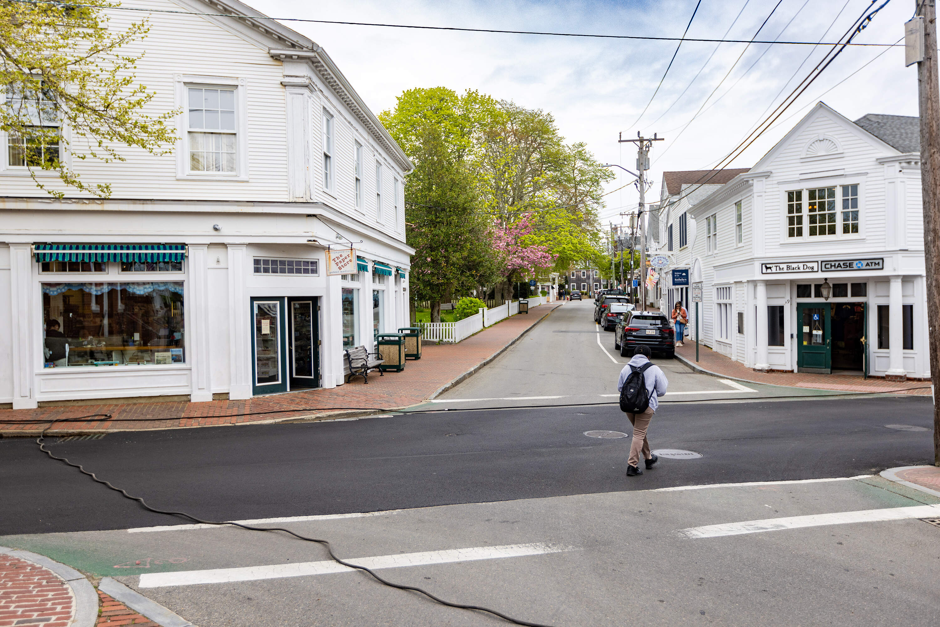 A man walks across the intersection of Main and North Water Streets in Edgartown, the location of the scene of the fourth of July parade in Downtown Amity in the movie Jaws. (Jesse Costa/WBUR)