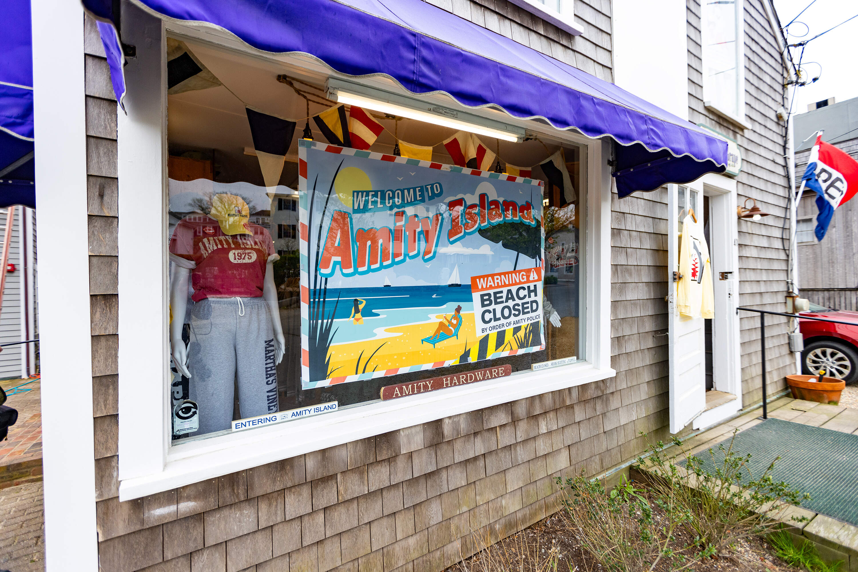 The front window of the gift shop Soft as a Grape in Edgartown emblazoned with references of Amity Island, the fictitious location in the film "Jaws." (Jesse Costa/WBUR)