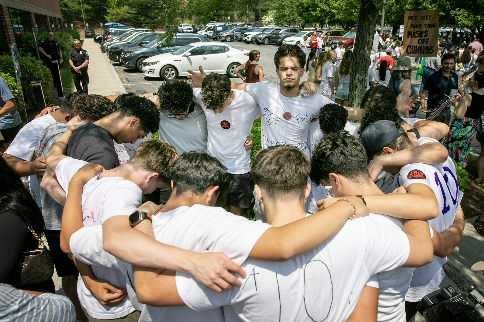 Friends and classmates of Marcelo Gomes Da Silva link arms in a circle after hearing that Gomes Da Silva would be released. (Robin Lubbock/WBUR)