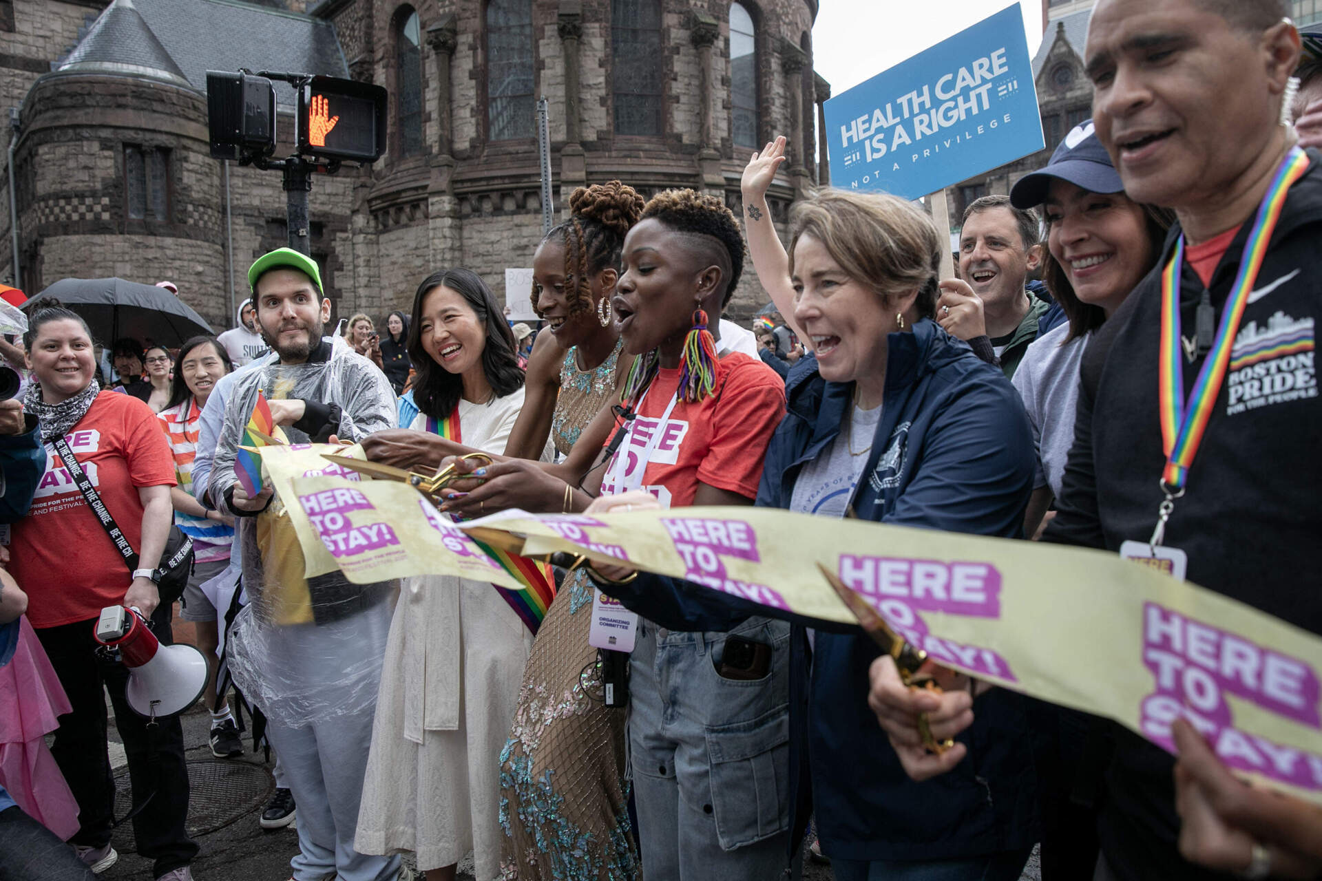 Boston Mayor Michelle Wu and and Mass. Gov. Maura Healey cut a ribbon to start the Boston Pride Parade. (Robin Lubbock/WBUR)