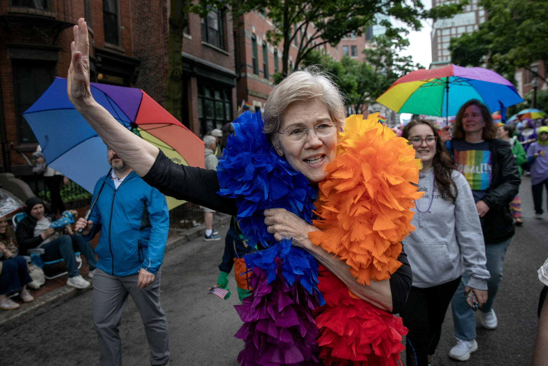 Sen. Elizabeth Warren wave to supporters at the Boston Pride Parade. (Robin Lubbock/WBUR)