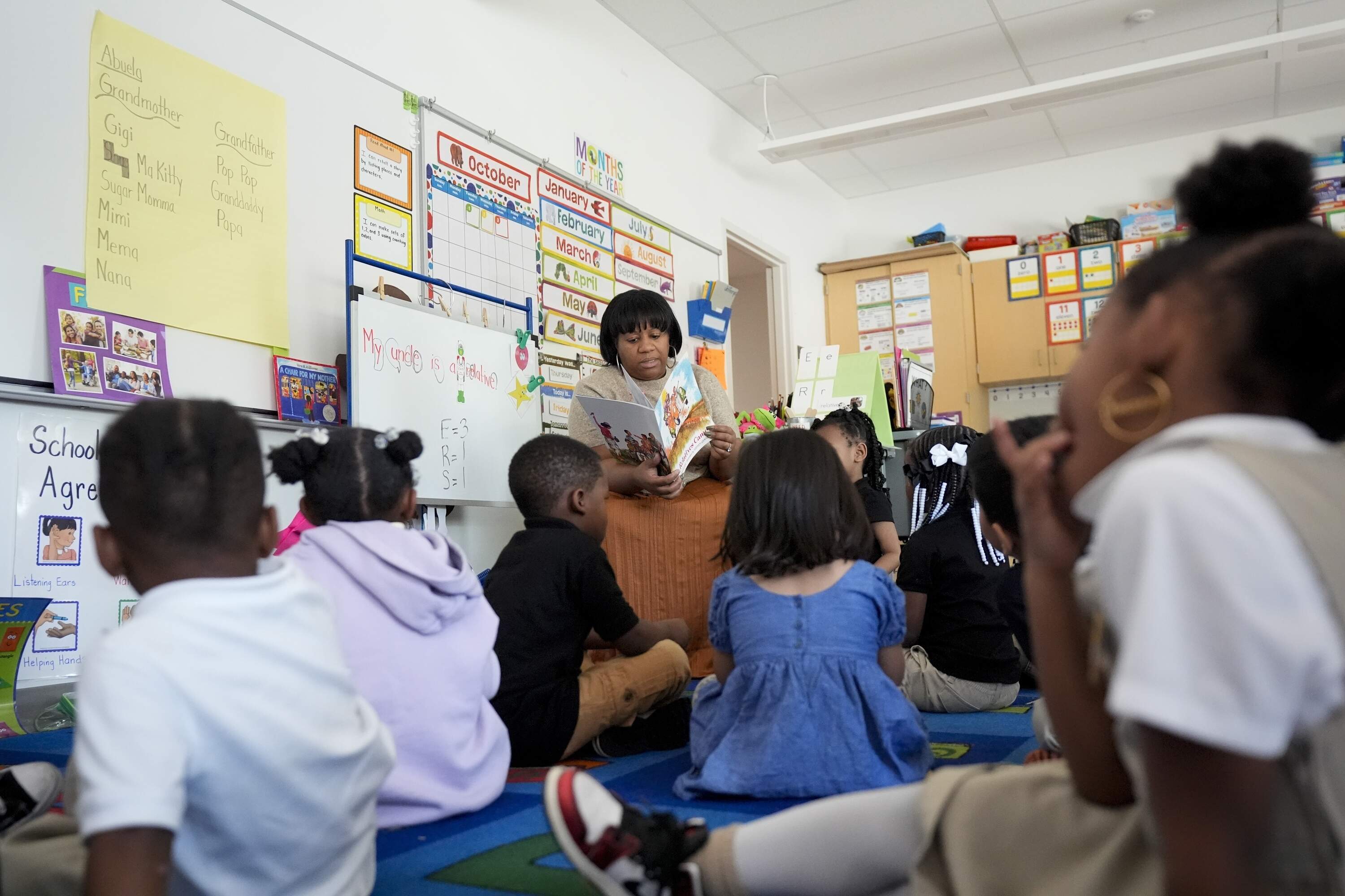 Preschool teacher Bridget Jeffreys reads to students, Thursday, Oct. 3, 2024, at Dorothy I. Height Elementary School in Baltimore. (Stephanie Scarbrough/AP)