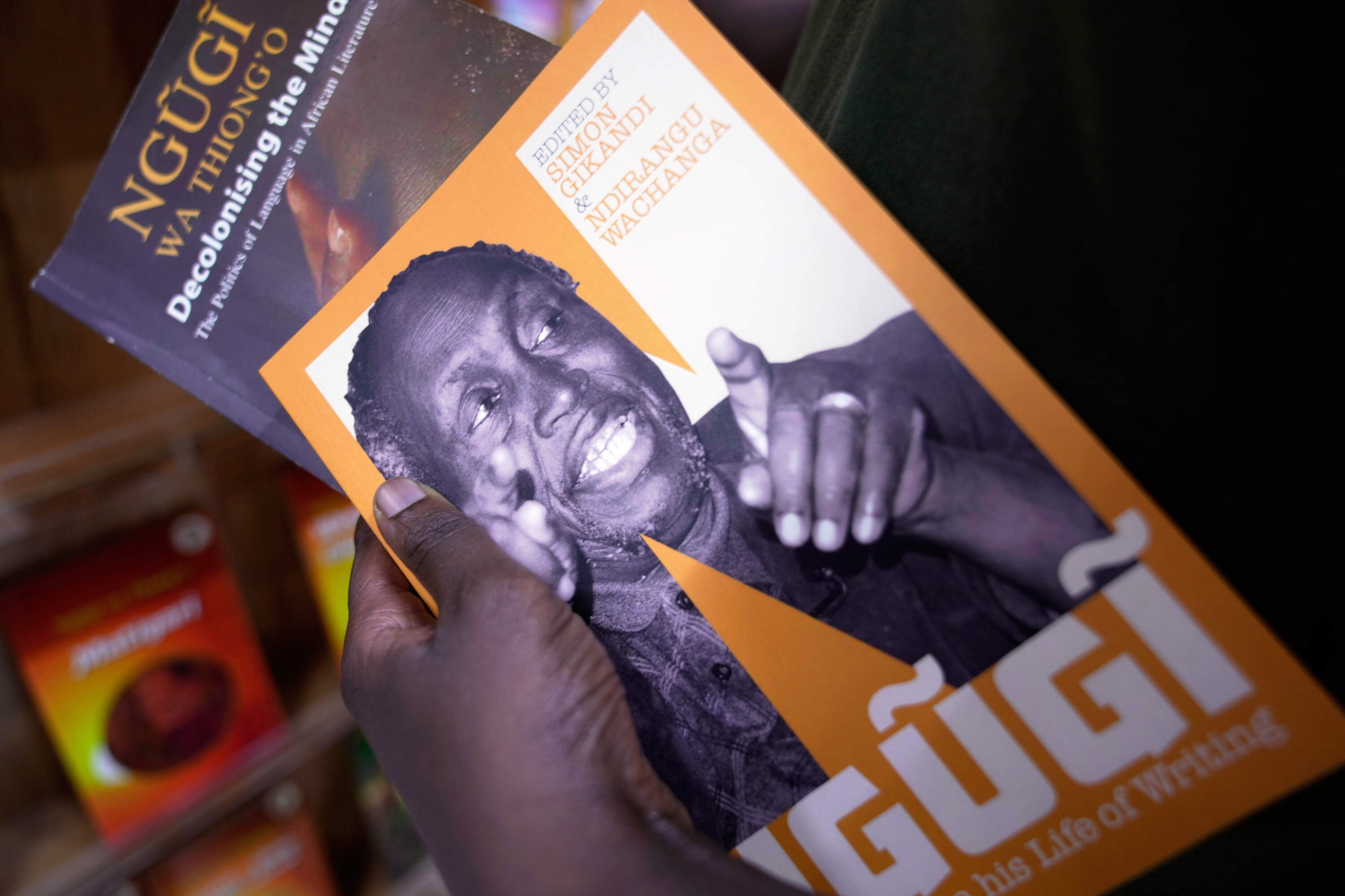 Bennet Mbata holds books of renowned Kenyan writer Ngugi wa Thiong'o, who died Wednesday in the U.S., at Nuria bookshop in Nairobi, Kenya, Thursday, May 29, 2025. (Brian Inganga/AP)