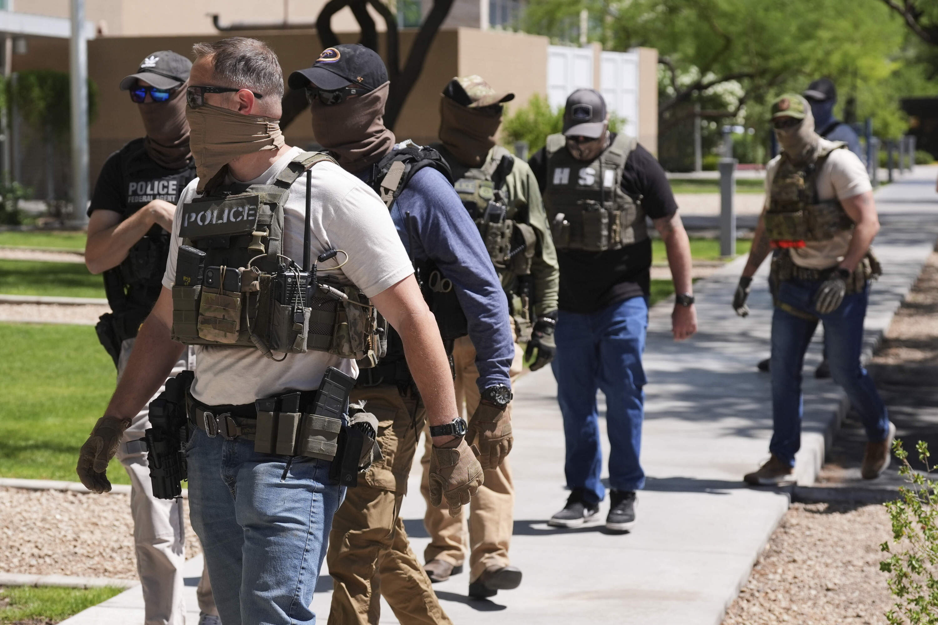 Immigration and Customs Enforcement and Homeland Security Investigations police arrive at an immigration court to take someone into custody, in Phoenix, May 21, 2025. (Ross D. Franklin/AP)
