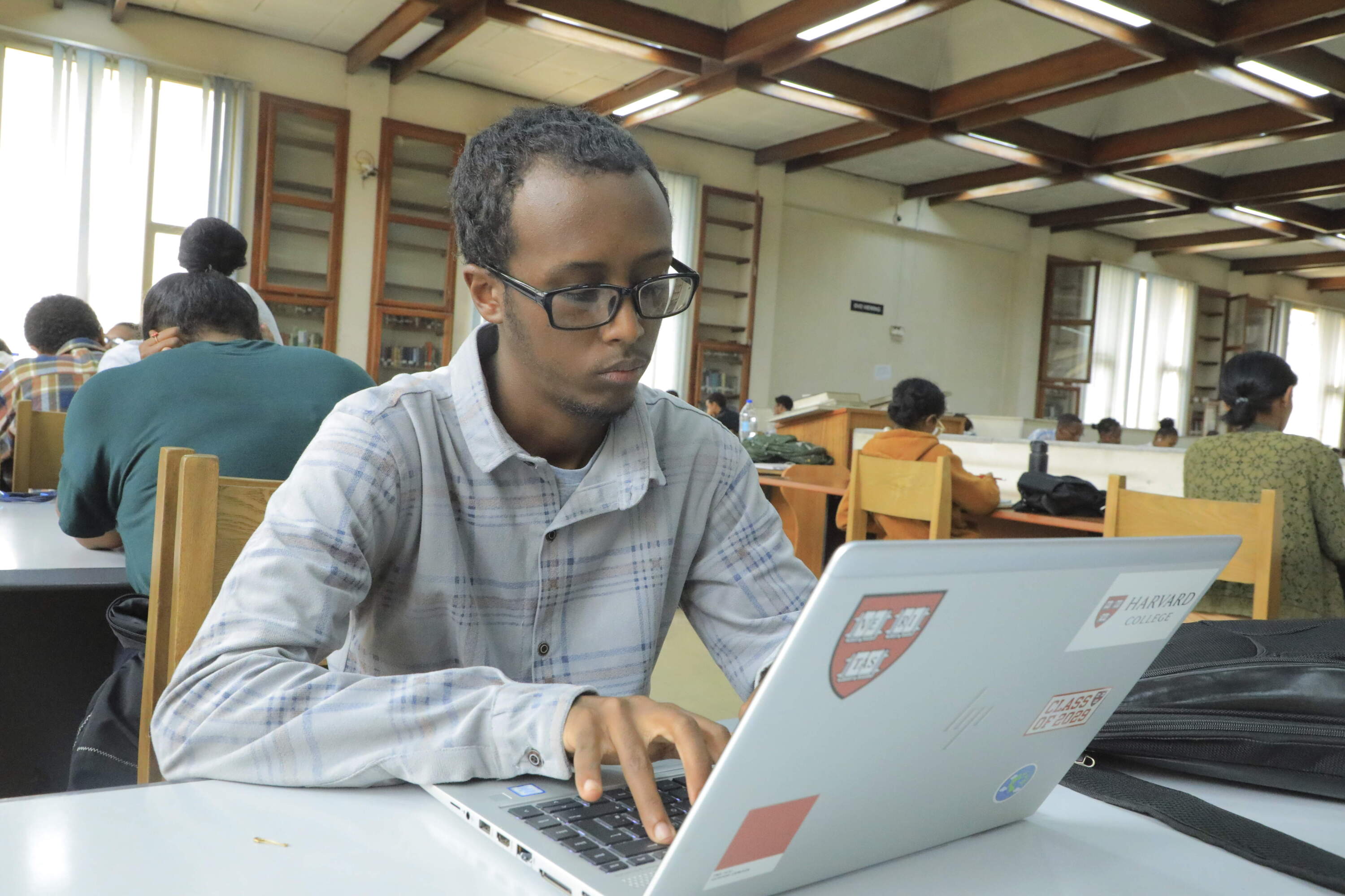 Yonas Nuguse, 21 years old and destined for Harvard University, works on a computer at Wemezeker National Library in Addis Ababa, Ethiopia. (Amanuel Birhane/AP)