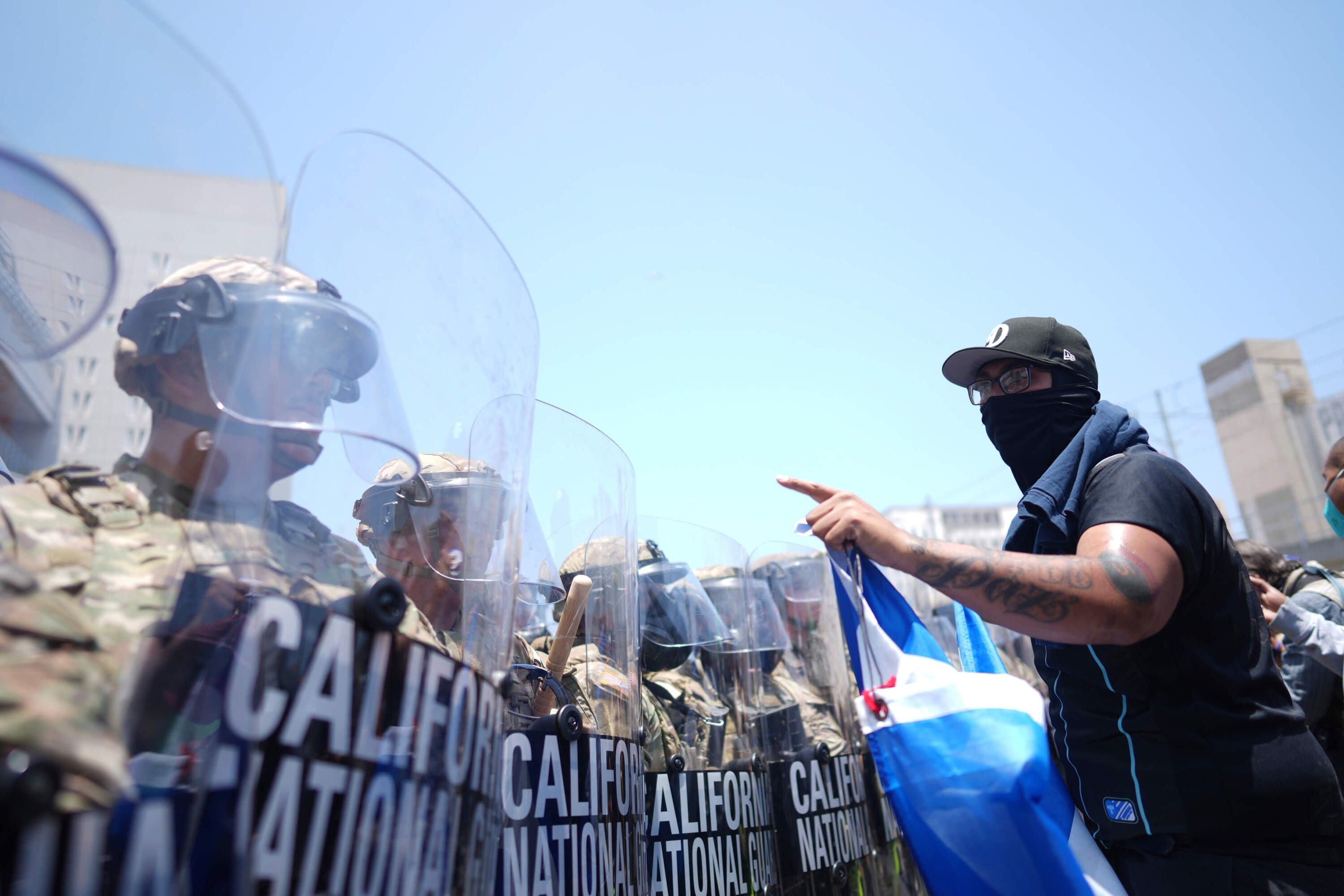 A protester confronts a line of U.S. National Guard in the metropolitan detention center of downtown Los Angeles, Sunday, June 8, 2025, following last night's immigration raid protest. (Eric Thayer/AP)