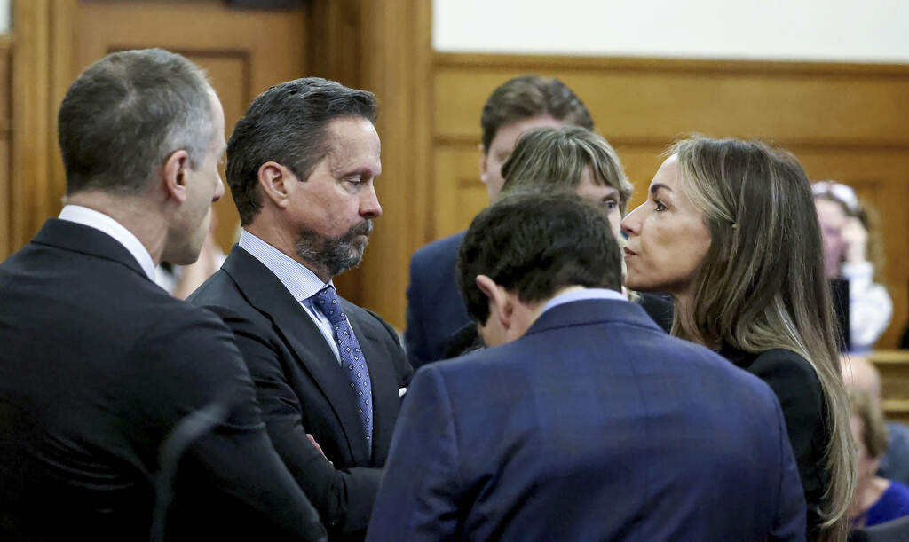 Defendant Karen Read, right, speaks to her defense team, including Alan Jackson, second from left, before closing arguments during her murder trial in Norfolk Superior Court (Mark Stockwell/The Sun Chronicle via AP)