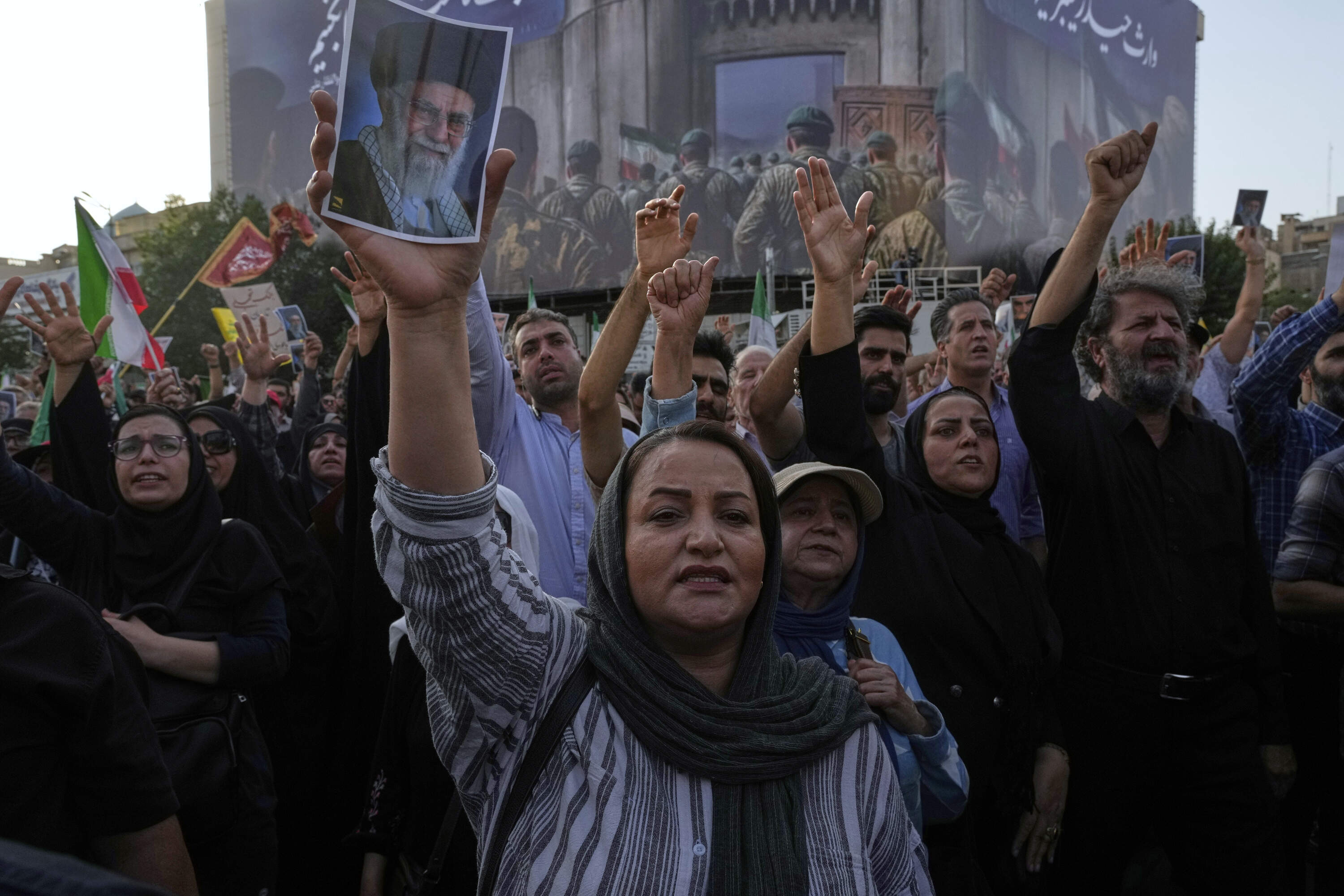 Protesters chant slogans as one of them holds up a poster of the Iranian Supreme Leader Ayatollah Ali Khamenei in a protest following the U.S. attacks on nuclear sites in Iran, in Tehran, Iran, Sunday, June 22, 2025. (Vahid Salemi/AP)